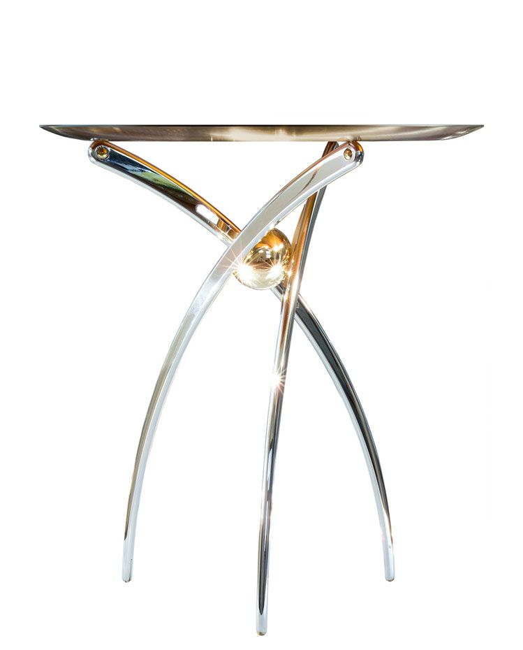 a silver table with a gold ball on top of it on a white background .