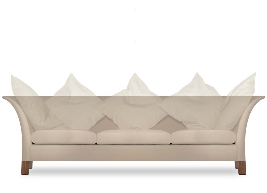 a white couch with a lot of pillows on it