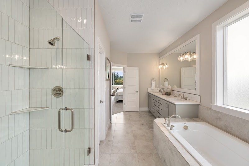 large bathroom with shower and tub and double vanity