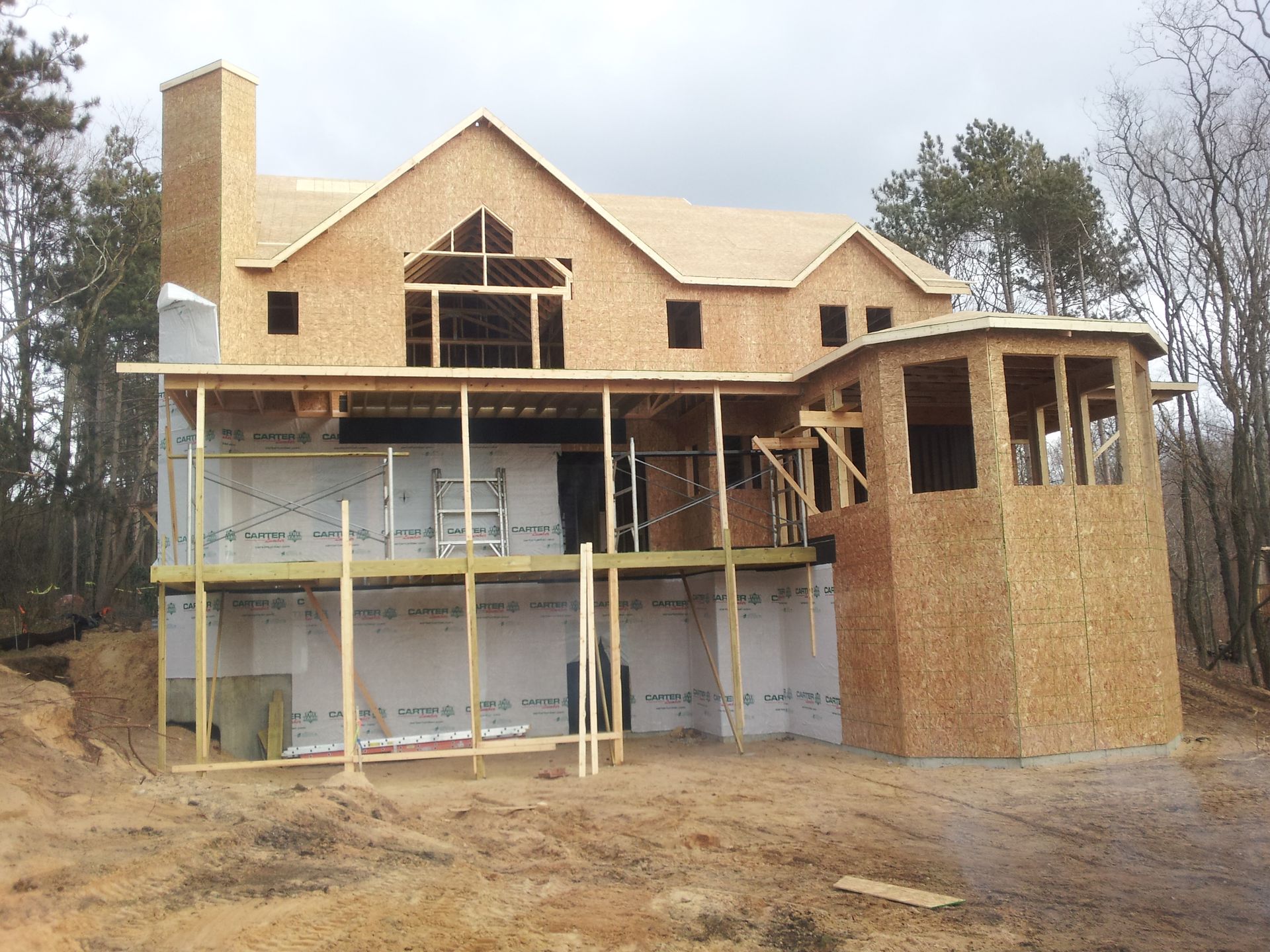 A large house is being built in the middle of a field