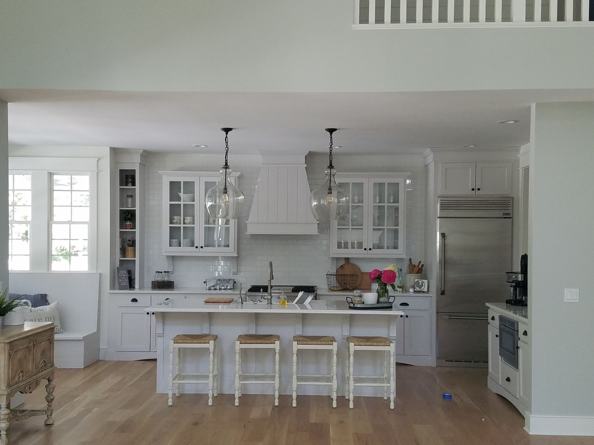 A kitchen with white cabinets and a large island