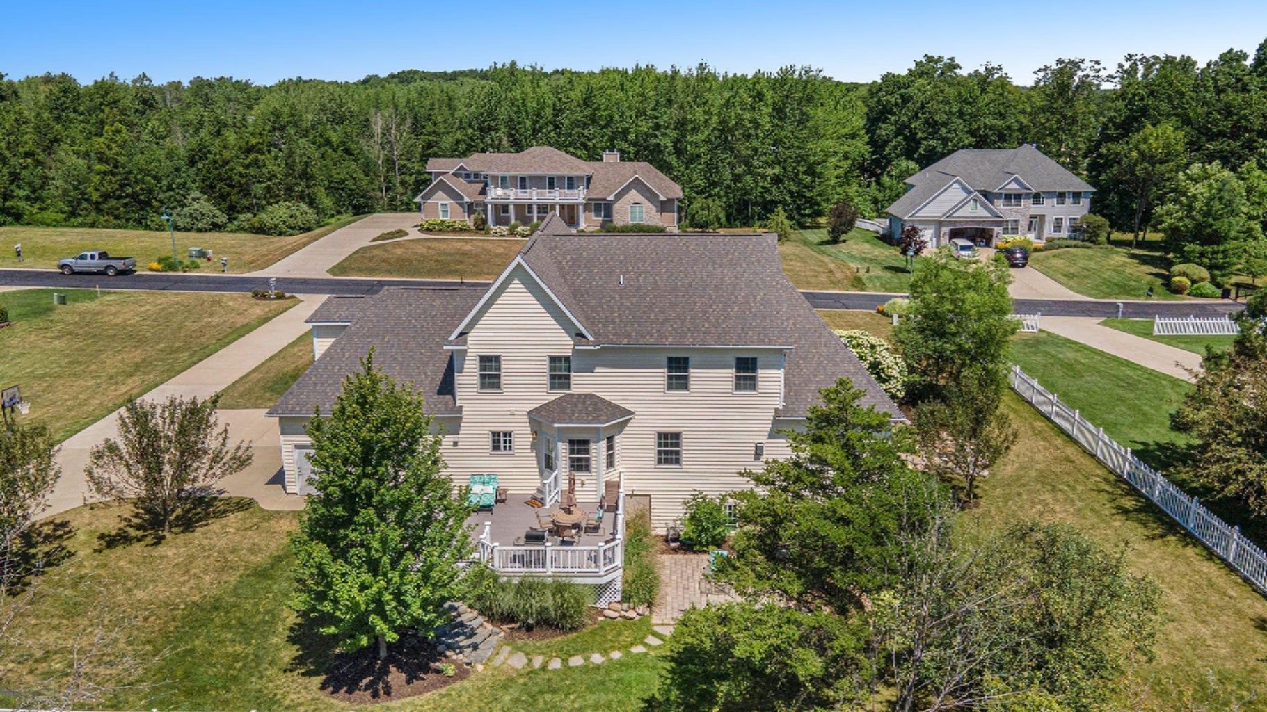 An aerial view of a large house surrounded by trees