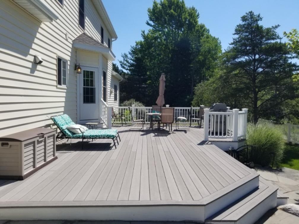 A large deck with a table and chairs on it
