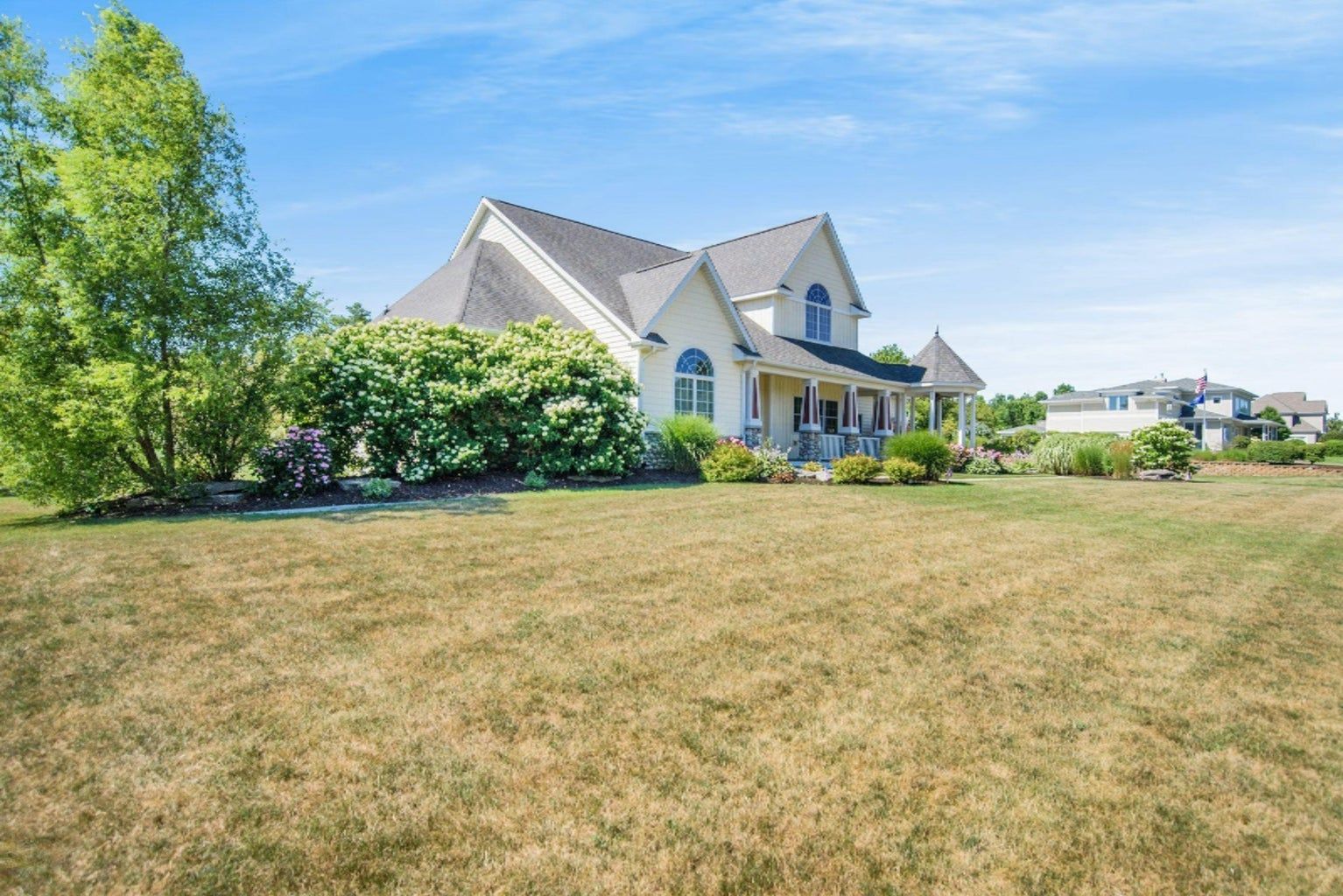 A large house with a large lawn in front of it.