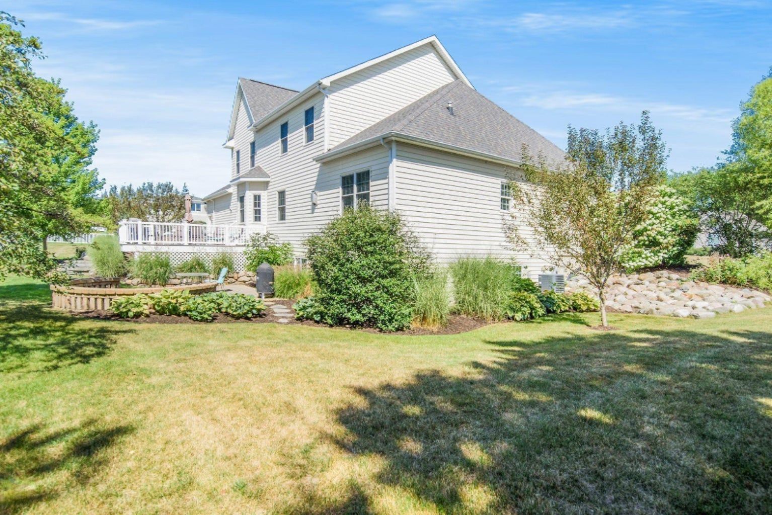A large white house with a large lawn in front of it.
