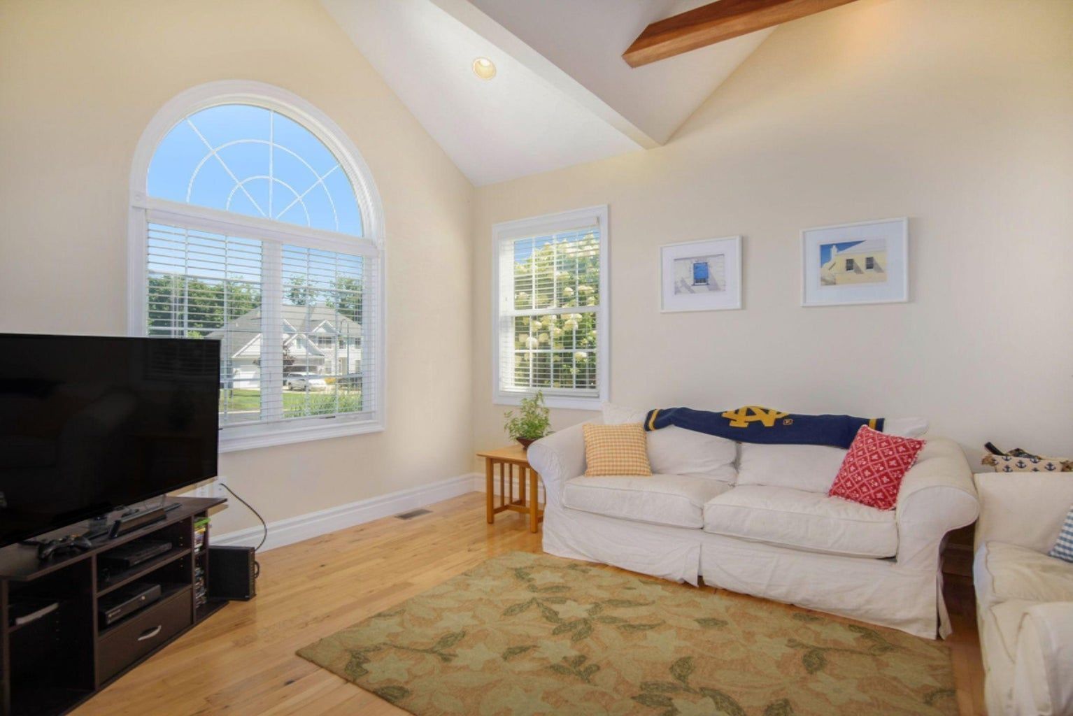A living room with a couch and a flat screen tv