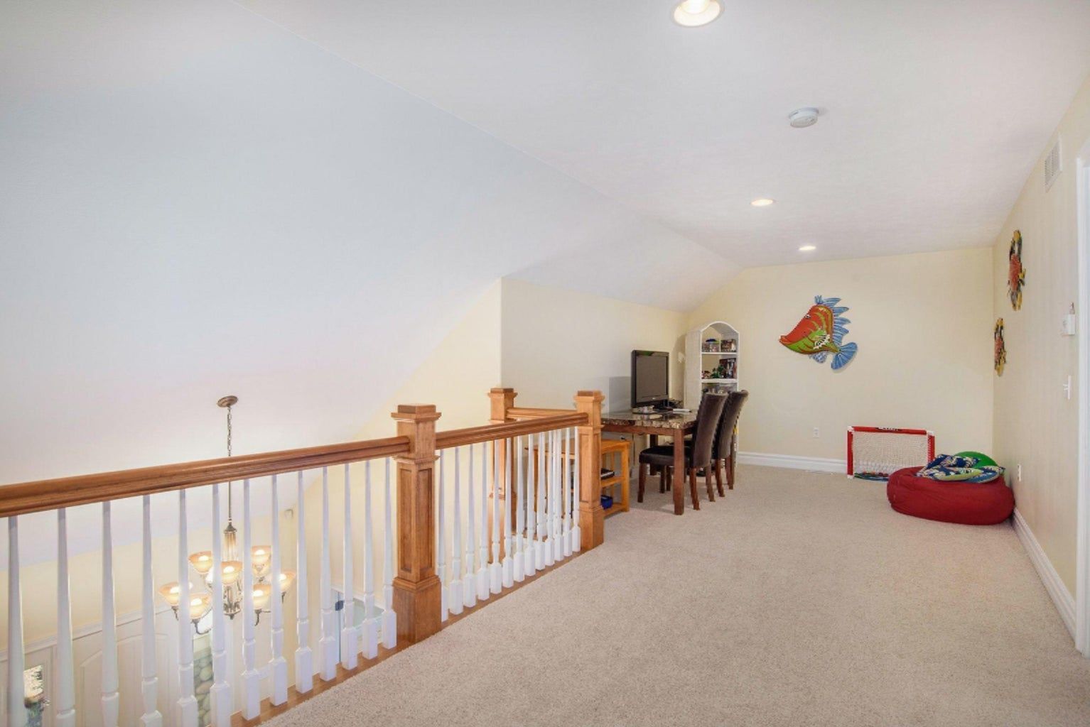 A living room with a staircase leading to the second floor.