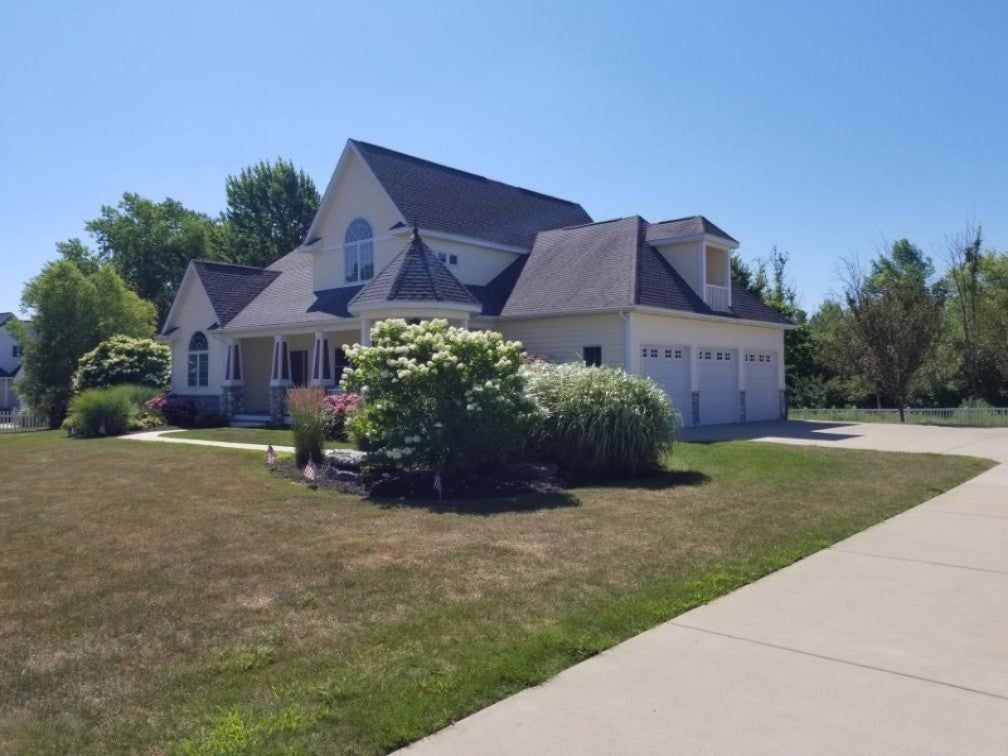A large white house with a gray roof