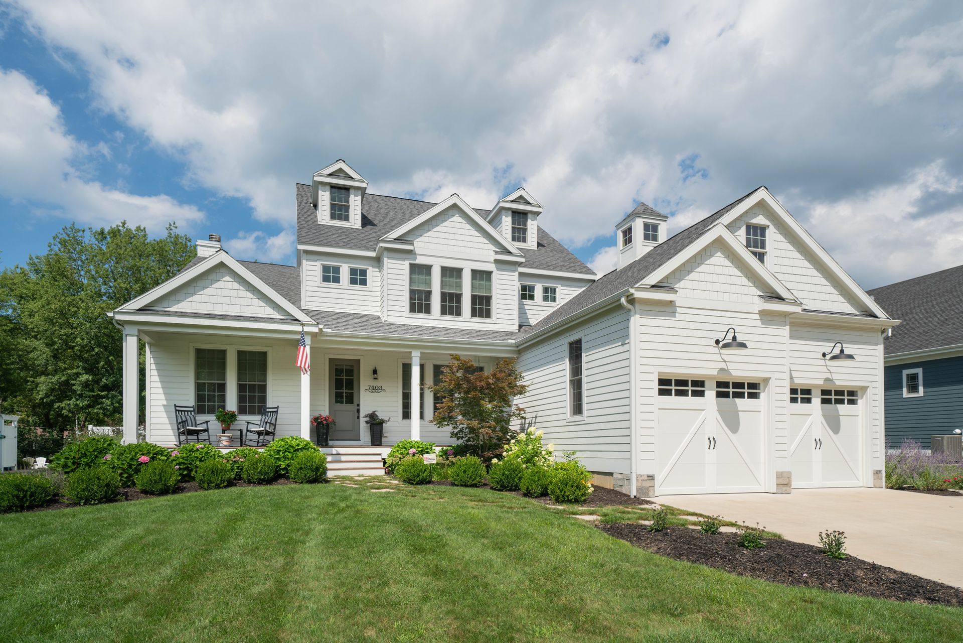 A large white house with a large lawn in front of it.
