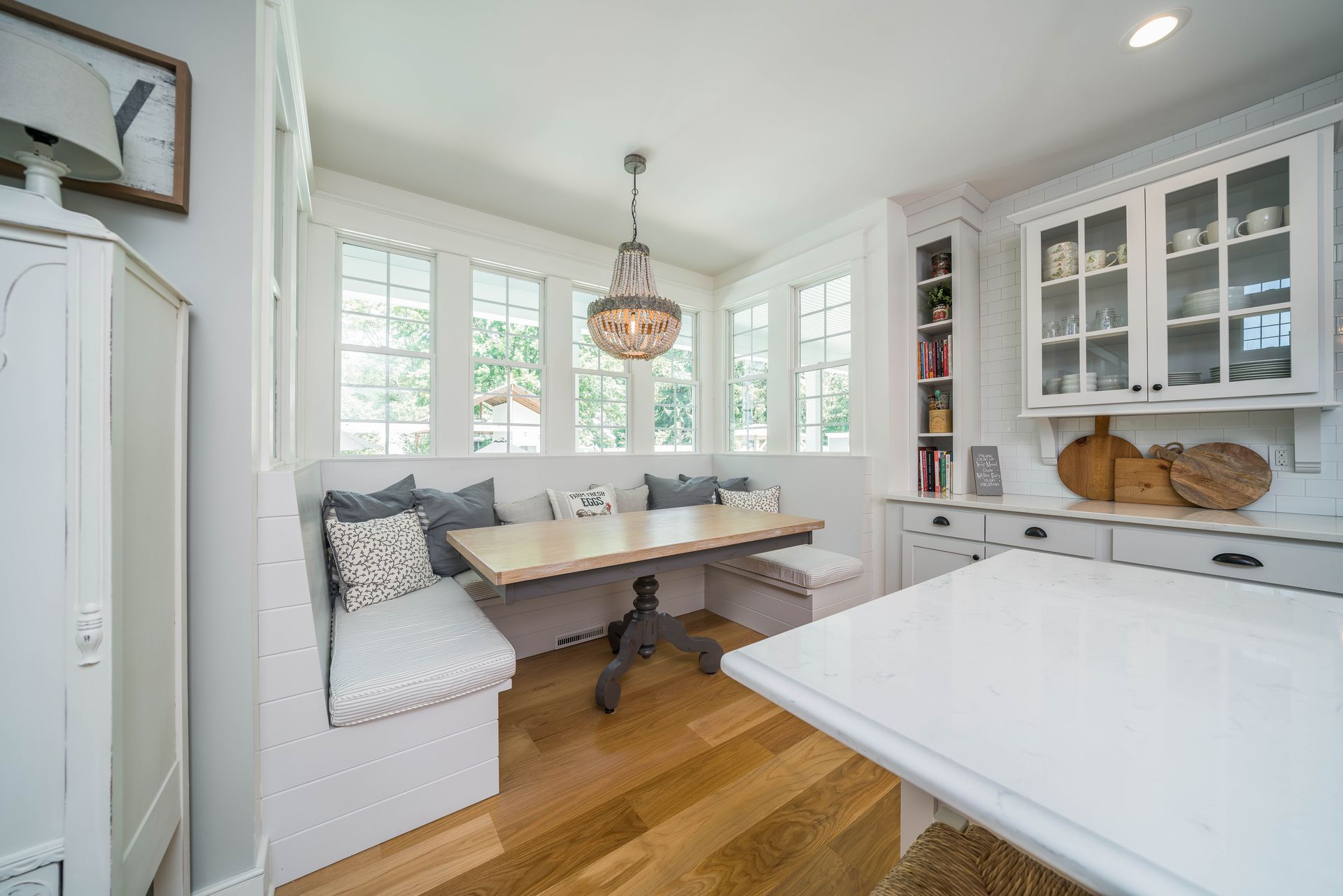 A kitchen with a table and benches in it.