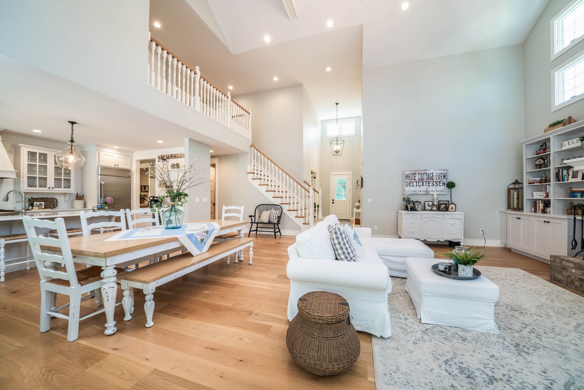 A living room and dining room in a house with a table and chairs.