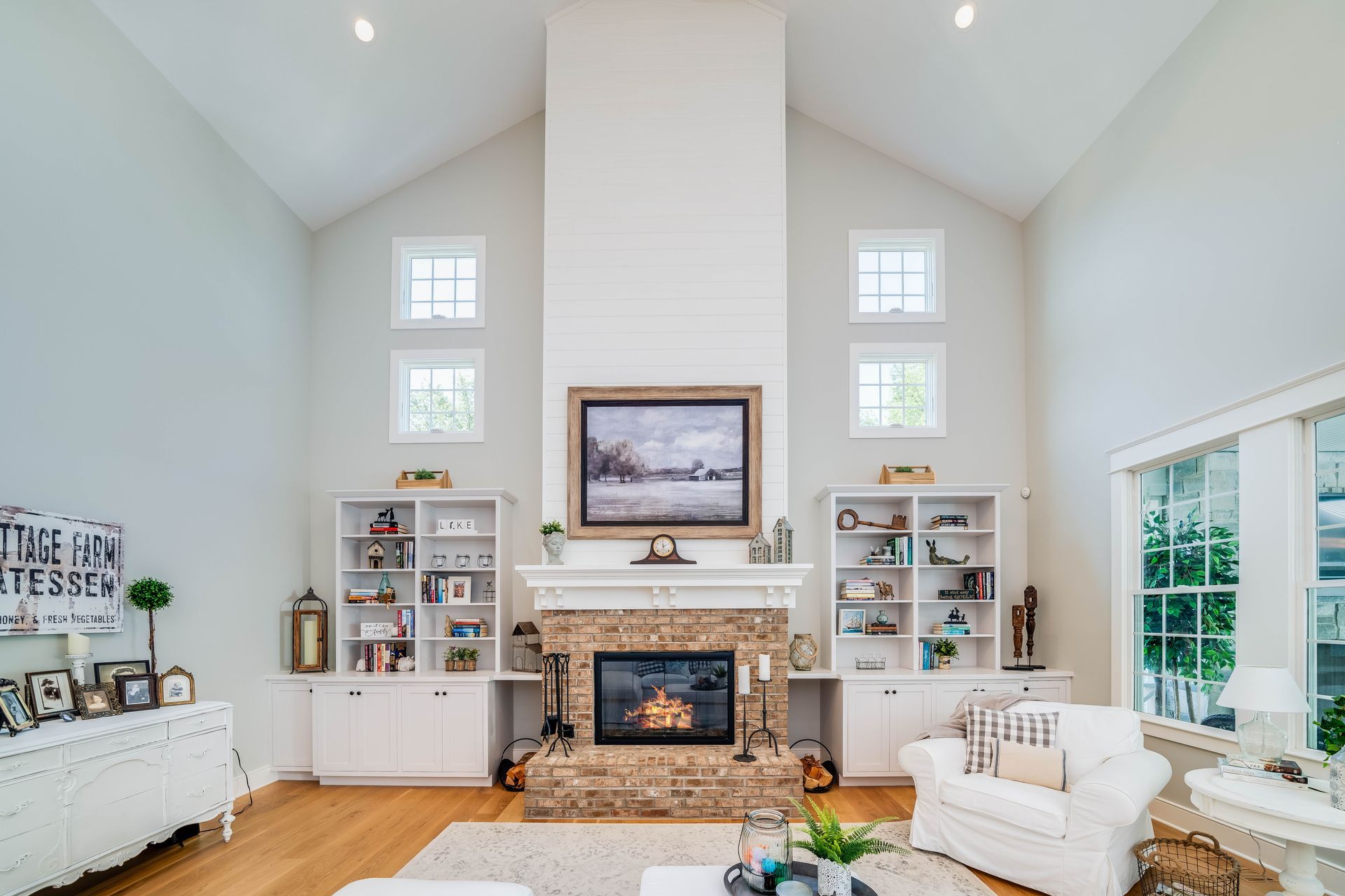 A living room with a fireplace and a flat screen tv