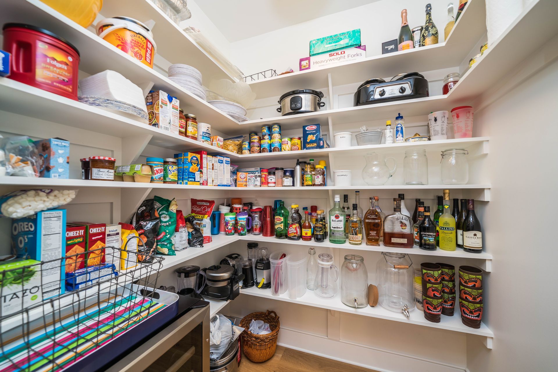 A pantry filled with lots of food and bottles.