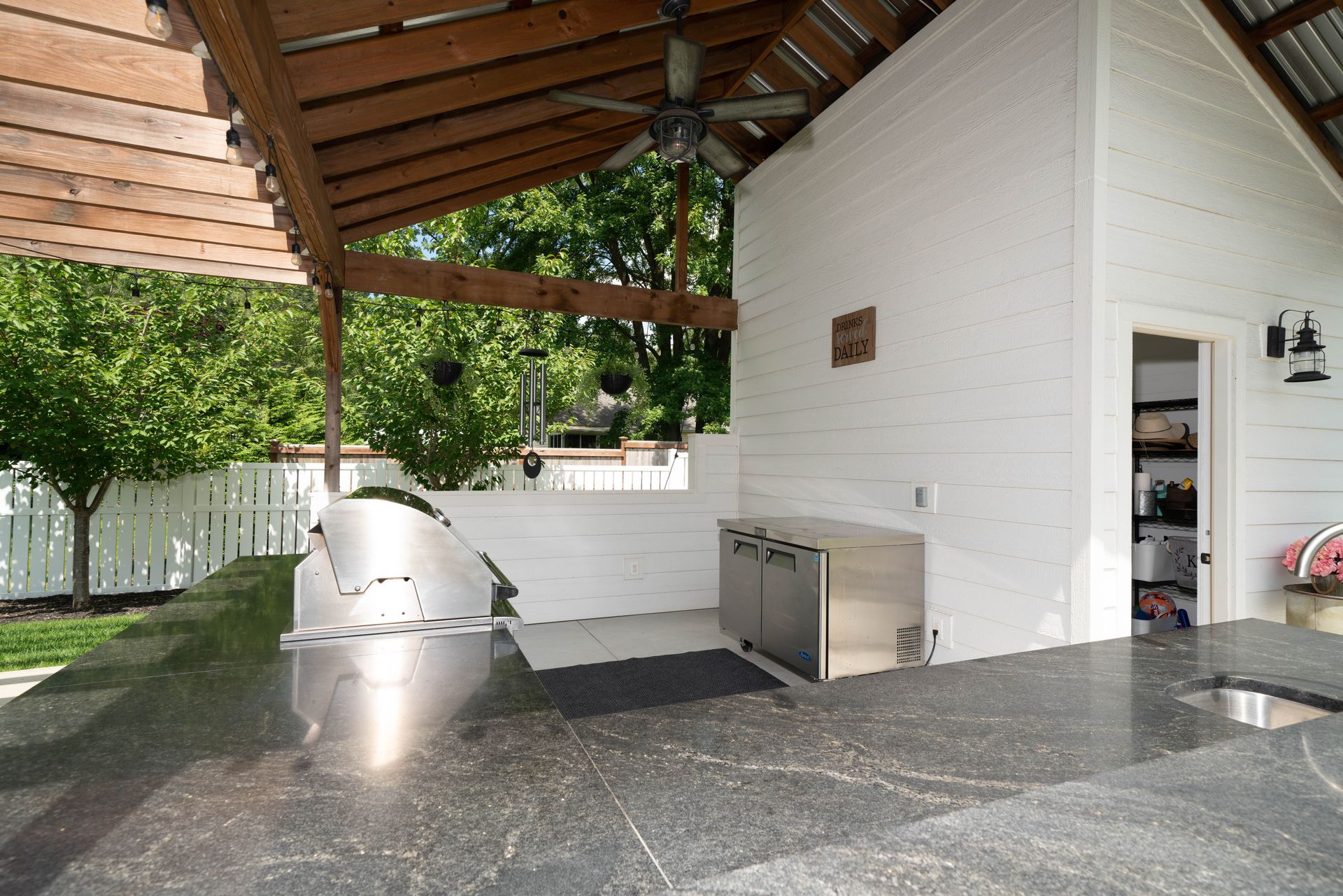 A kitchen with a stainless steel grill and a ceiling fan