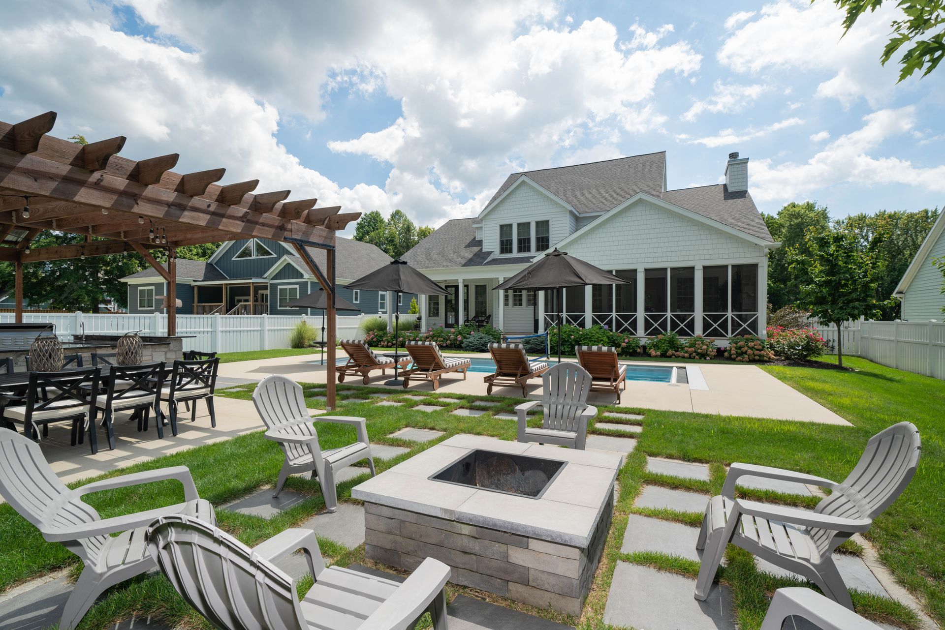 There is a fire pit in the middle of the backyard.