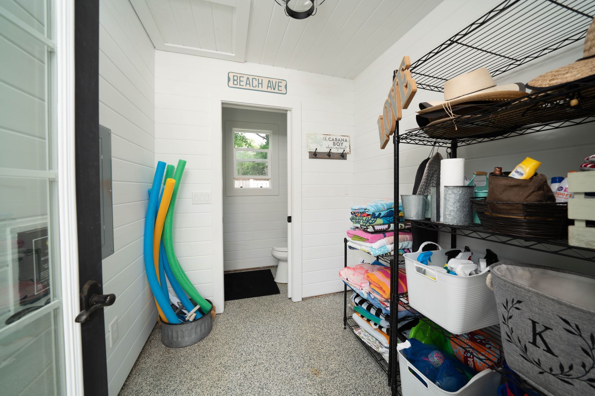 A room with a lot of shelves and baskets in it.