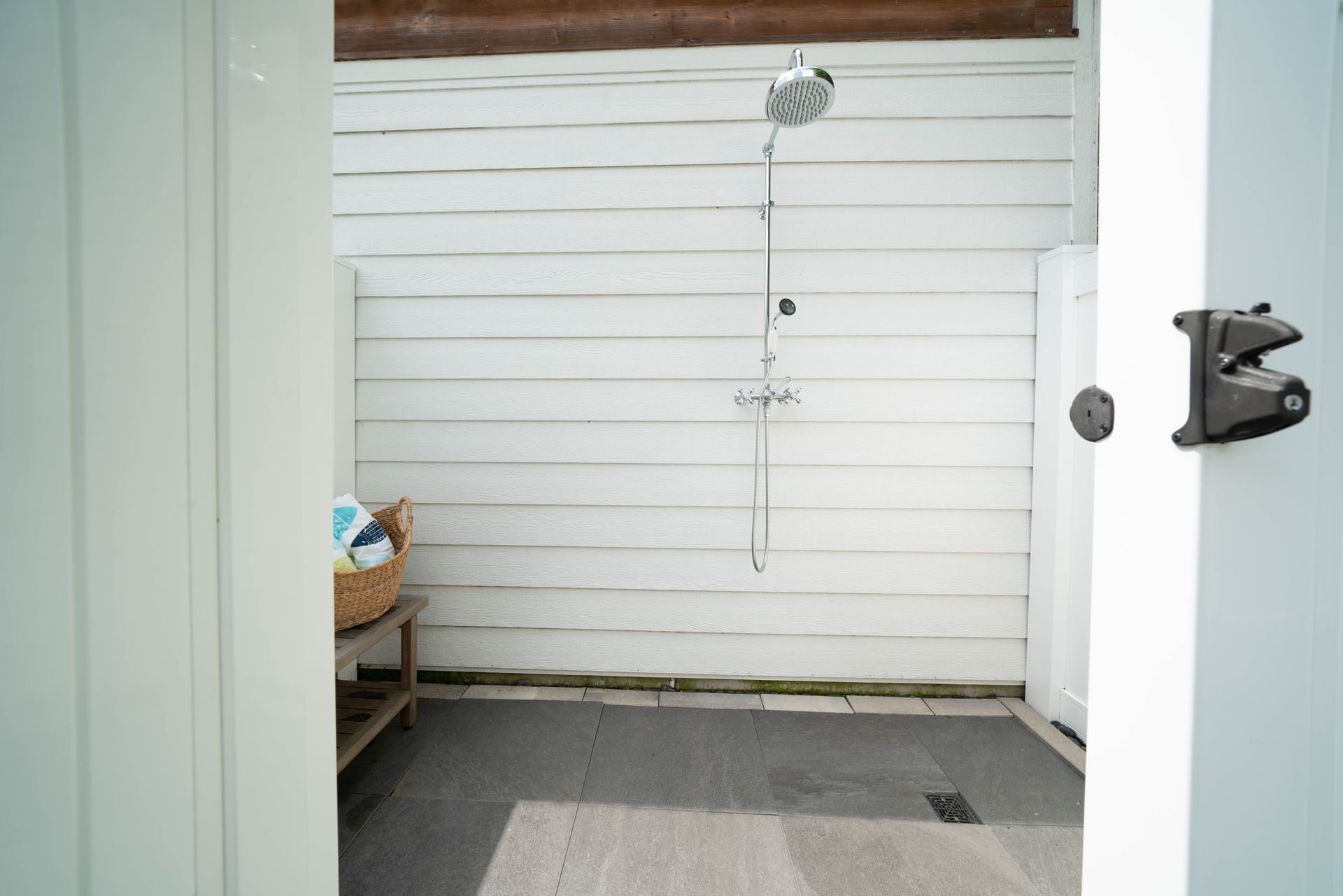 A bathroom with a shower and a rug on the floor.