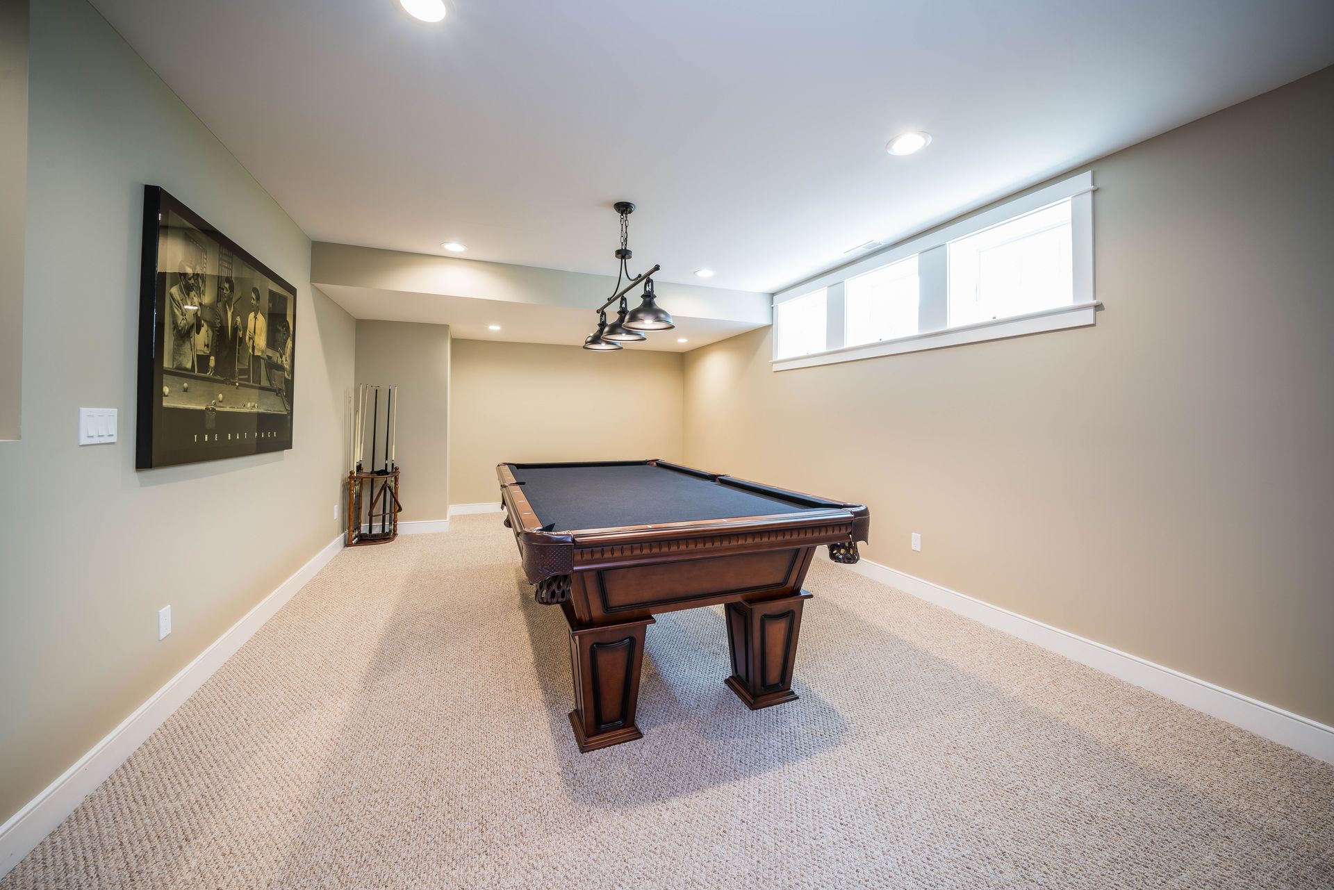 There is a pool table in the middle of the room.