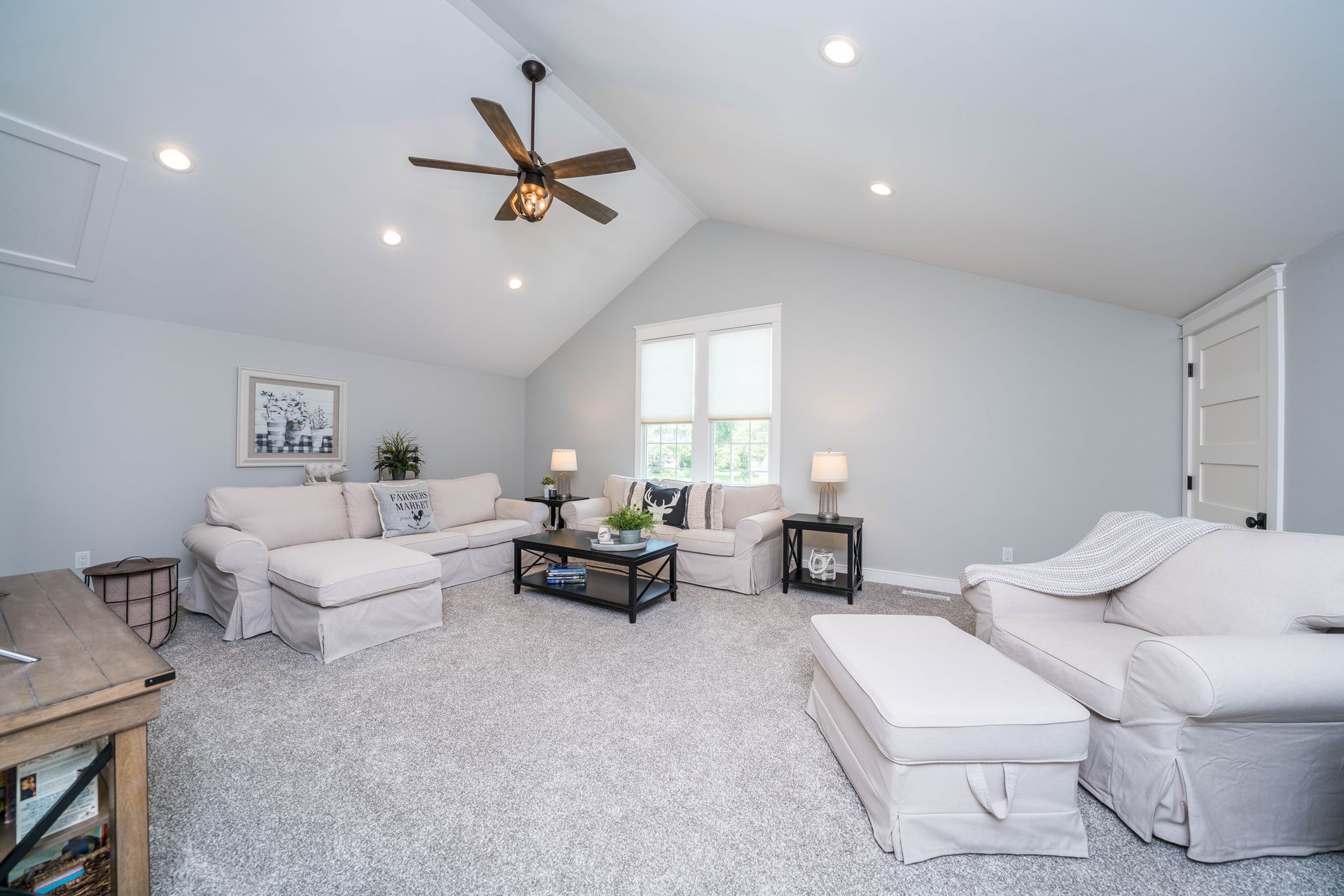 A living room filled with furniture and a ceiling fan.