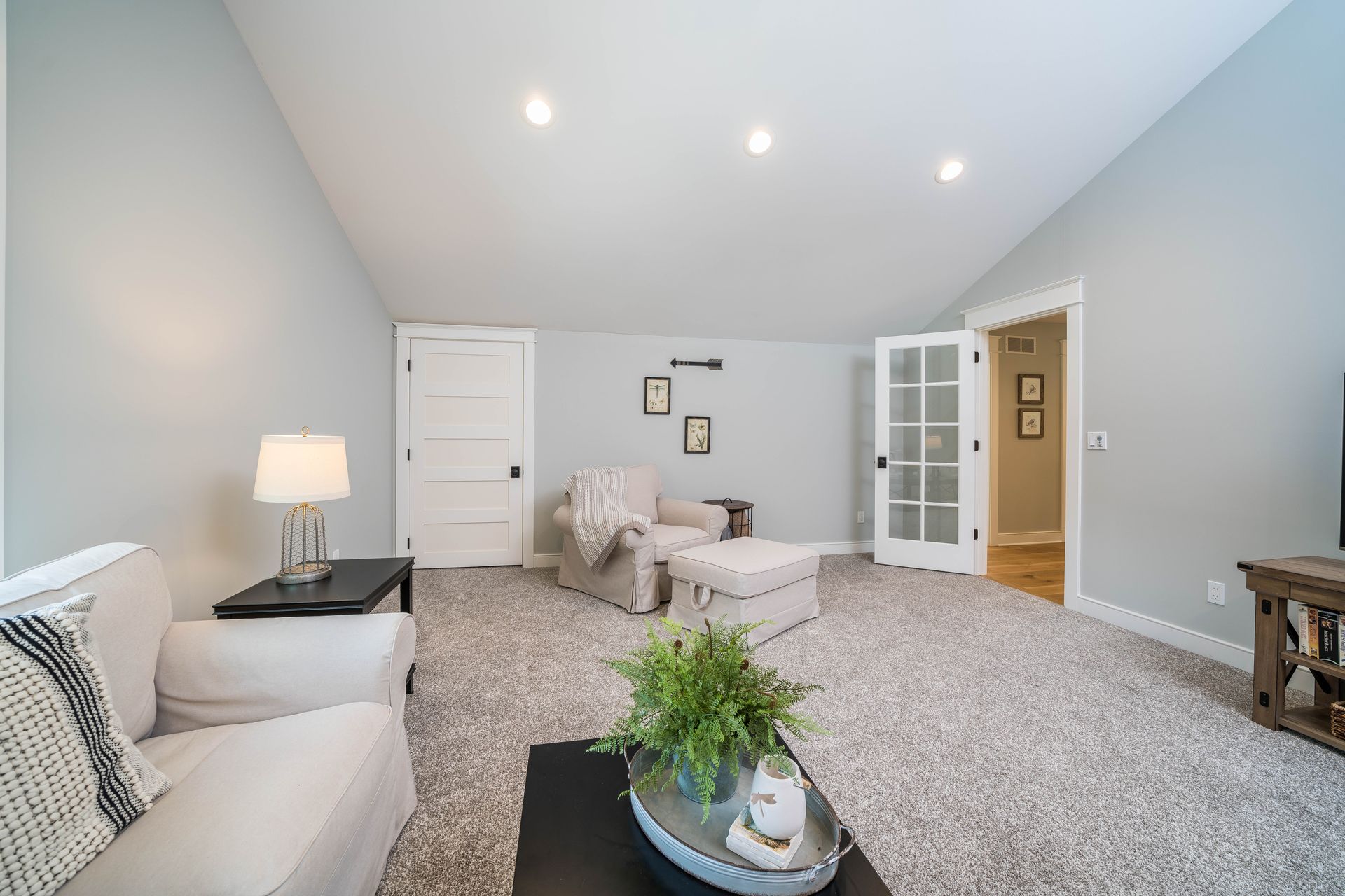 A living room with a couch , chair and ottoman.