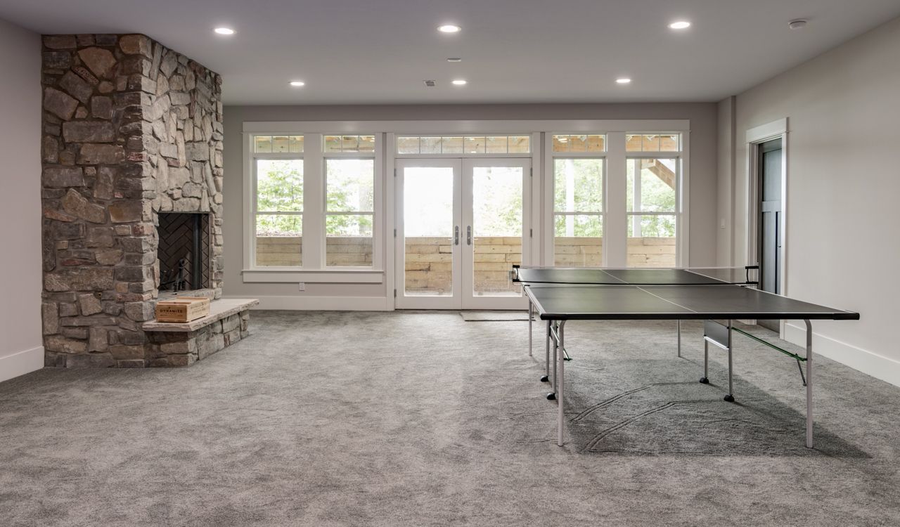 There is a ping pong table in the middle of the room.