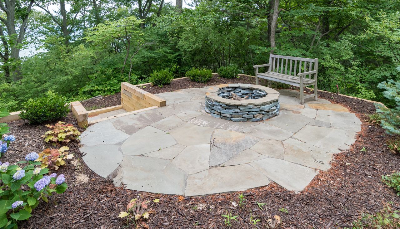 There is a fire pit in the middle of the patio.