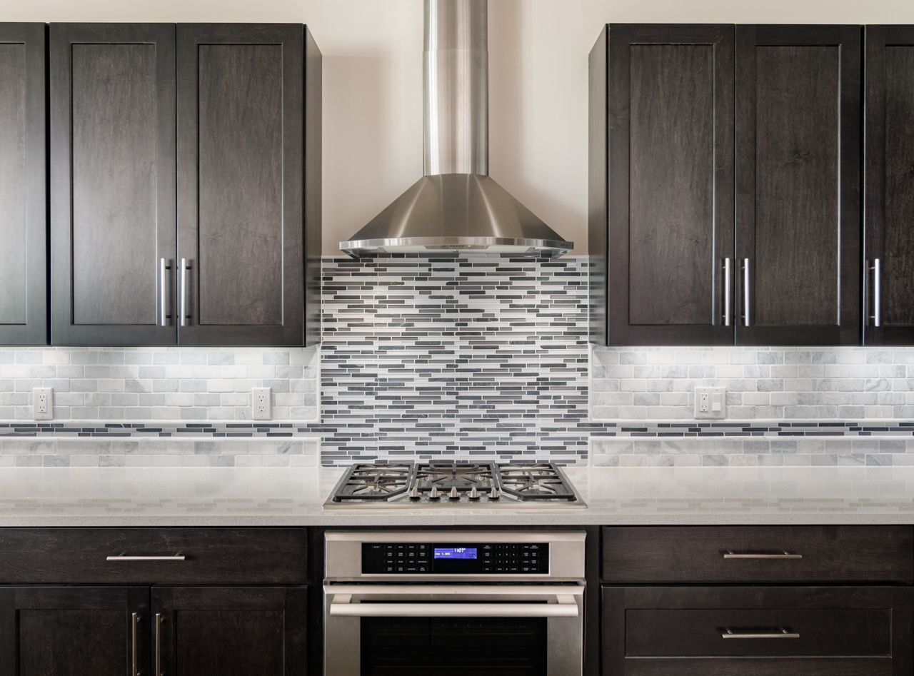 A kitchen with stainless steel appliances and wooden cabinets.