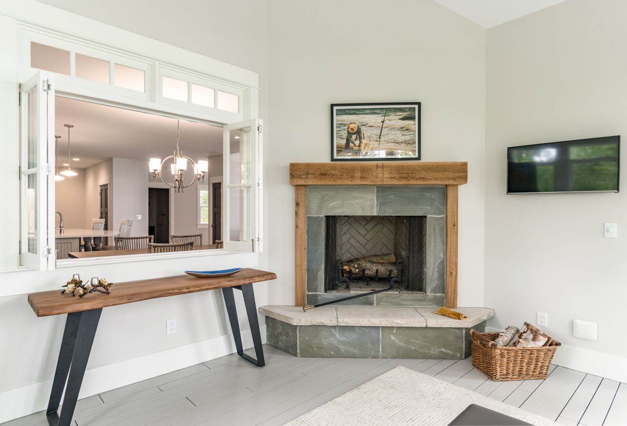 A living room with a fireplace and a television.
