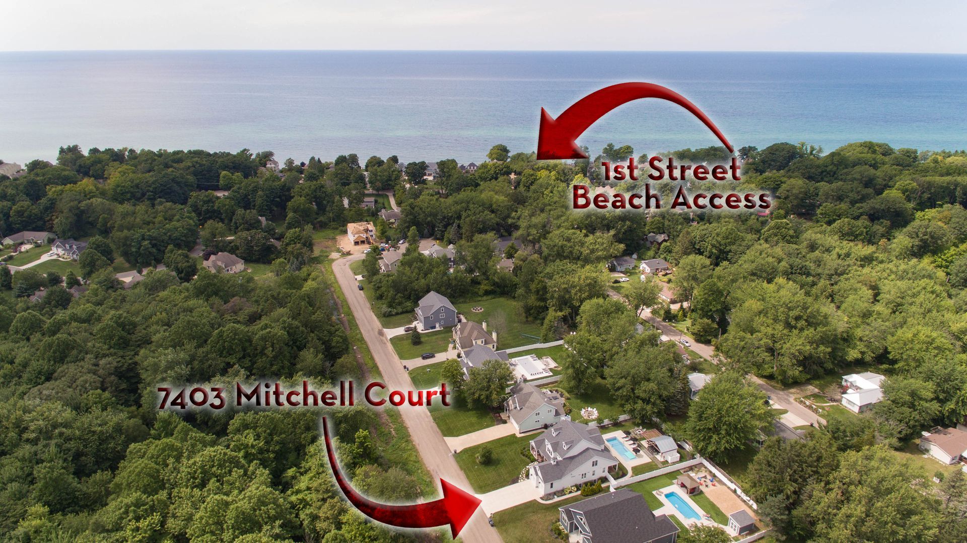 An aerial view of a residential area with a beach access