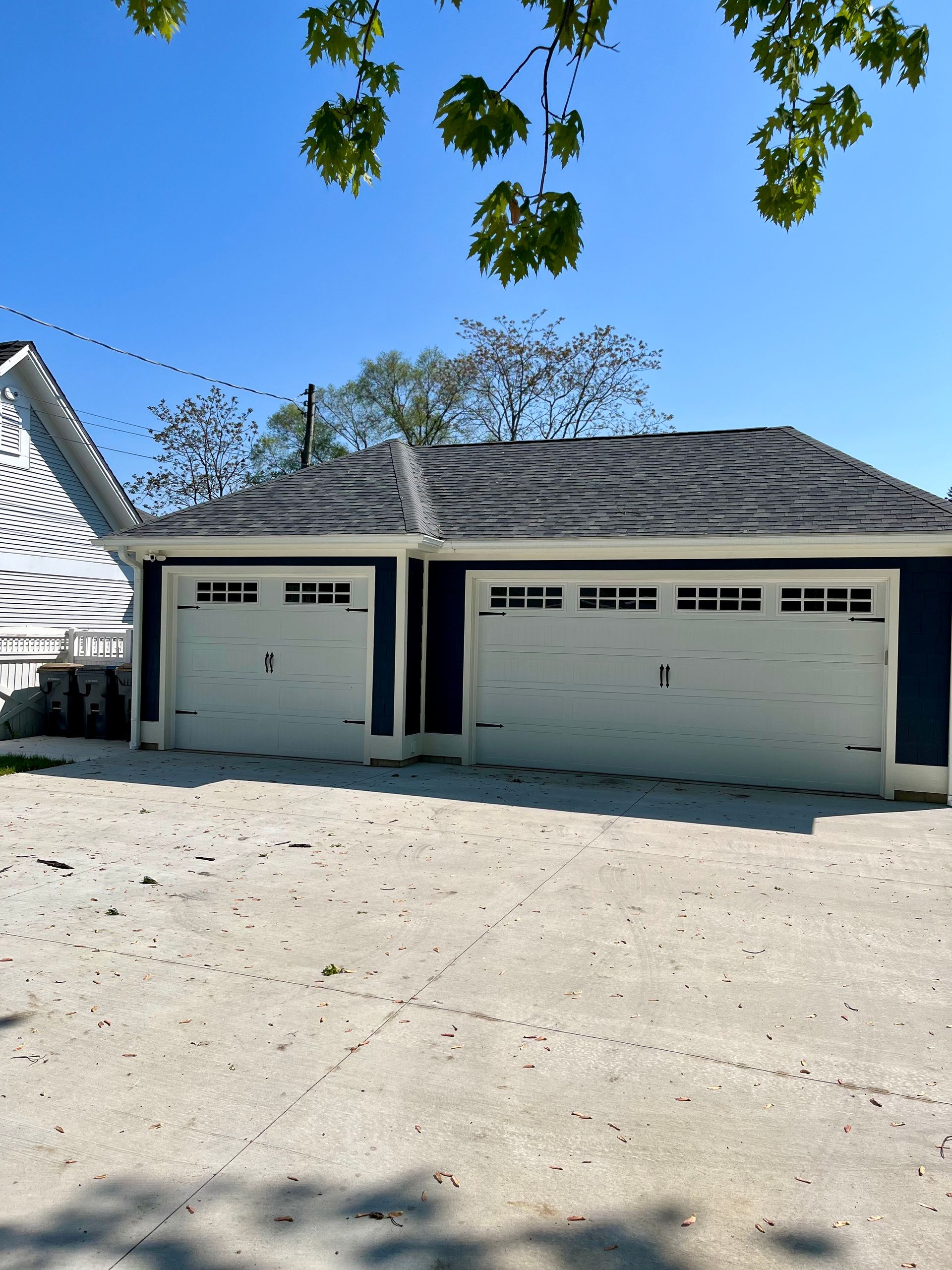 A blue and white house with two garage doors