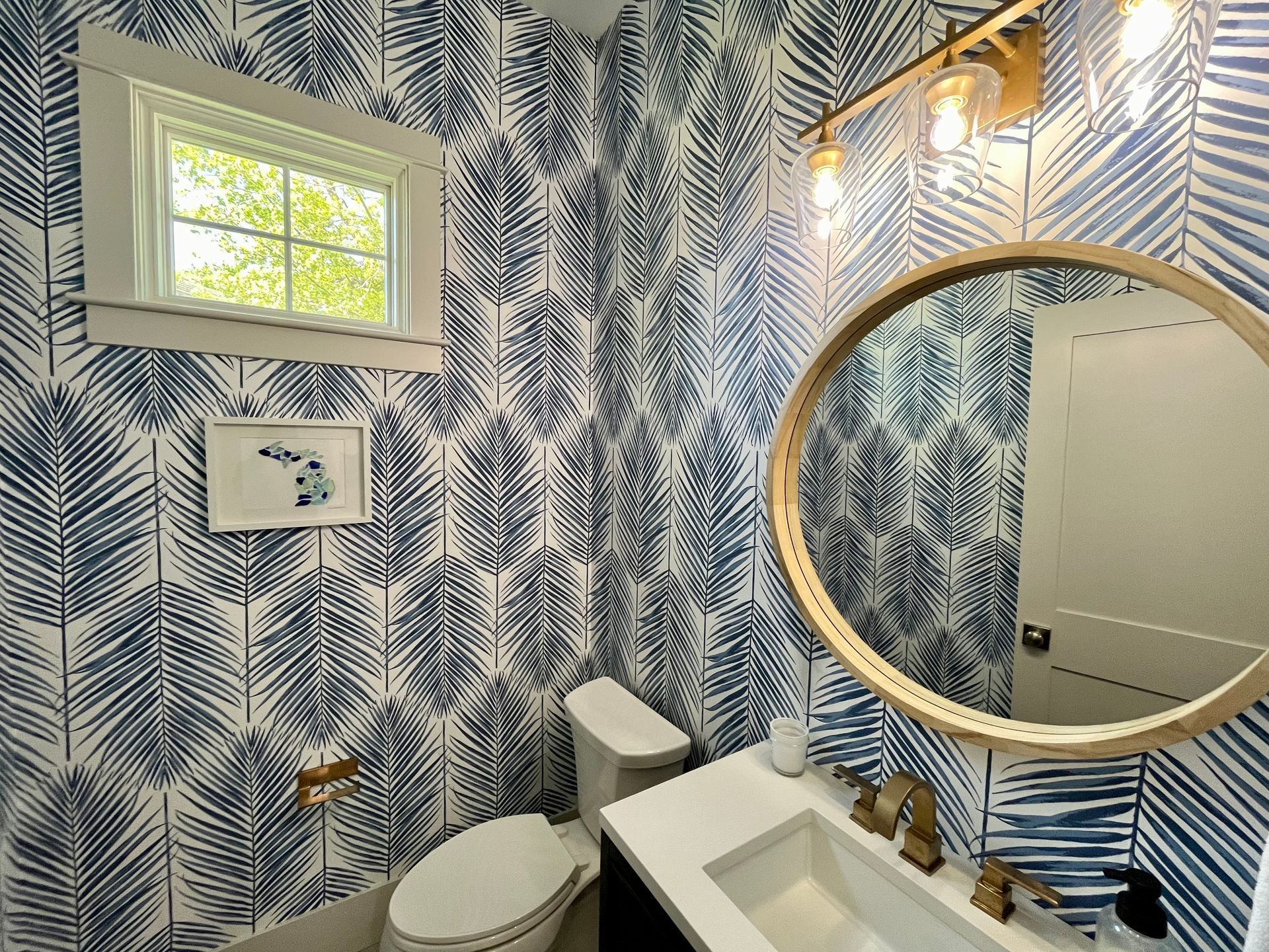 A bathroom with a toilet , sink , and mirror.