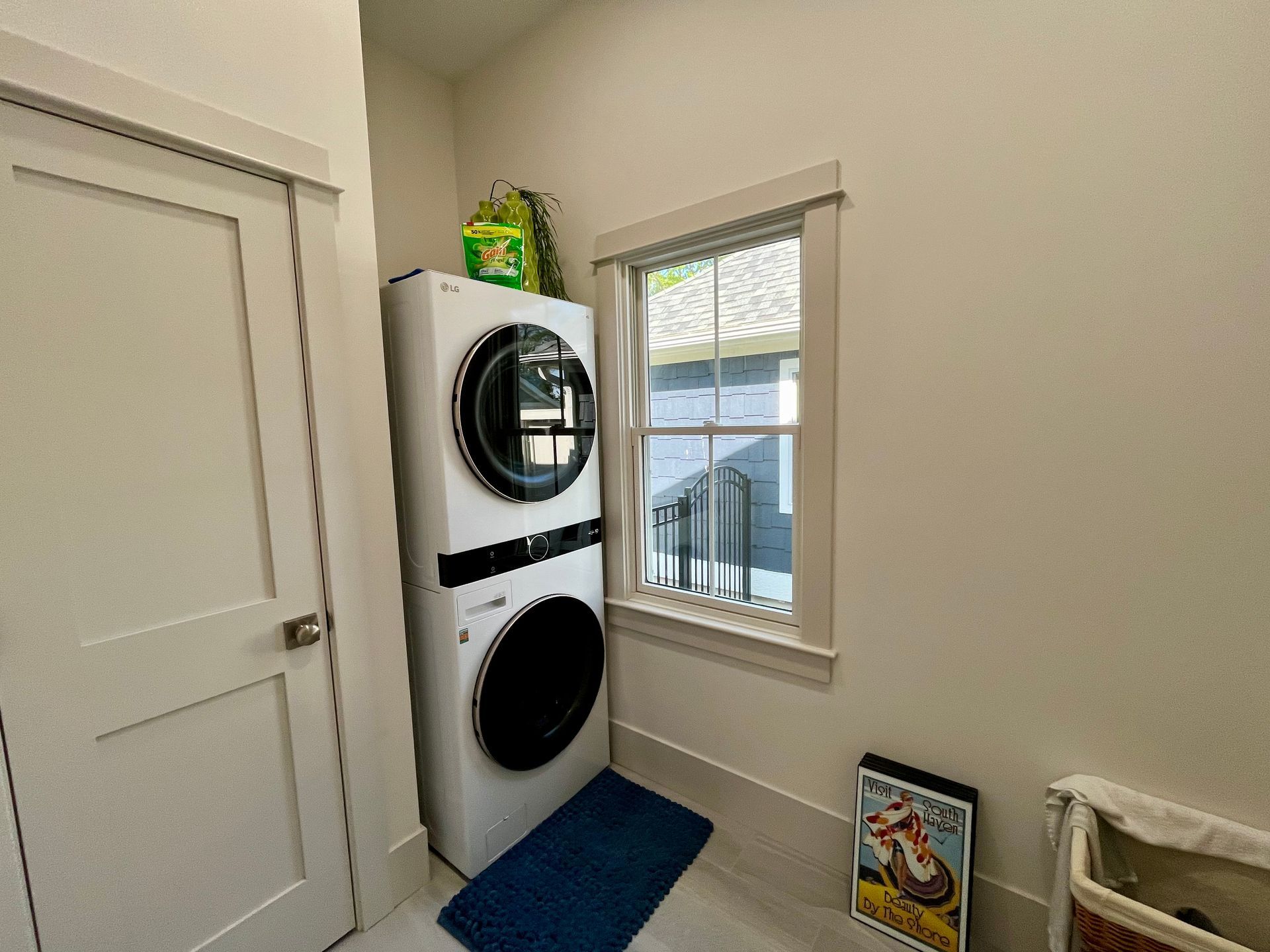 A laundry room with a washer and dryer stacked on top of each other.