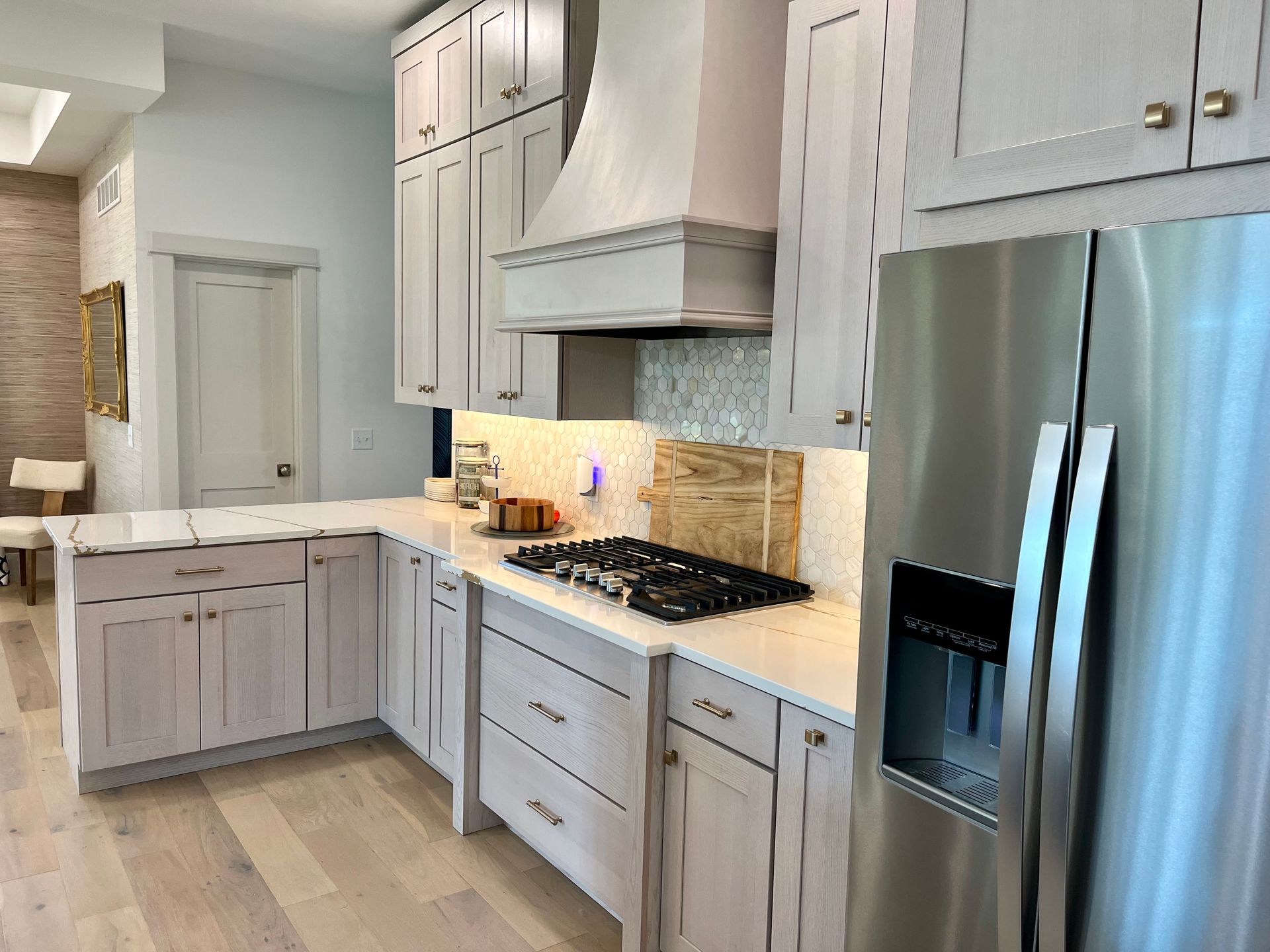 A kitchen with white cabinets and stainless steel appliances.