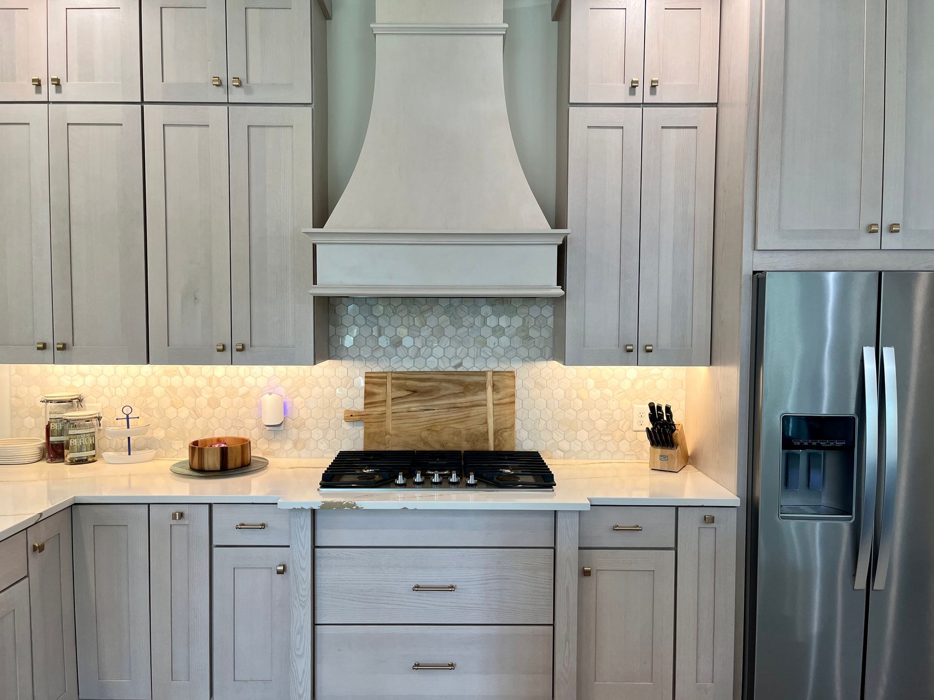 A kitchen with white cabinets and stainless steel appliances.