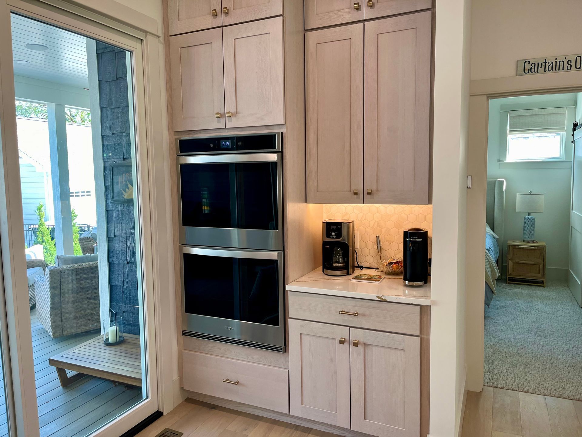 A kitchen with stainless steel appliances and white cabinets.