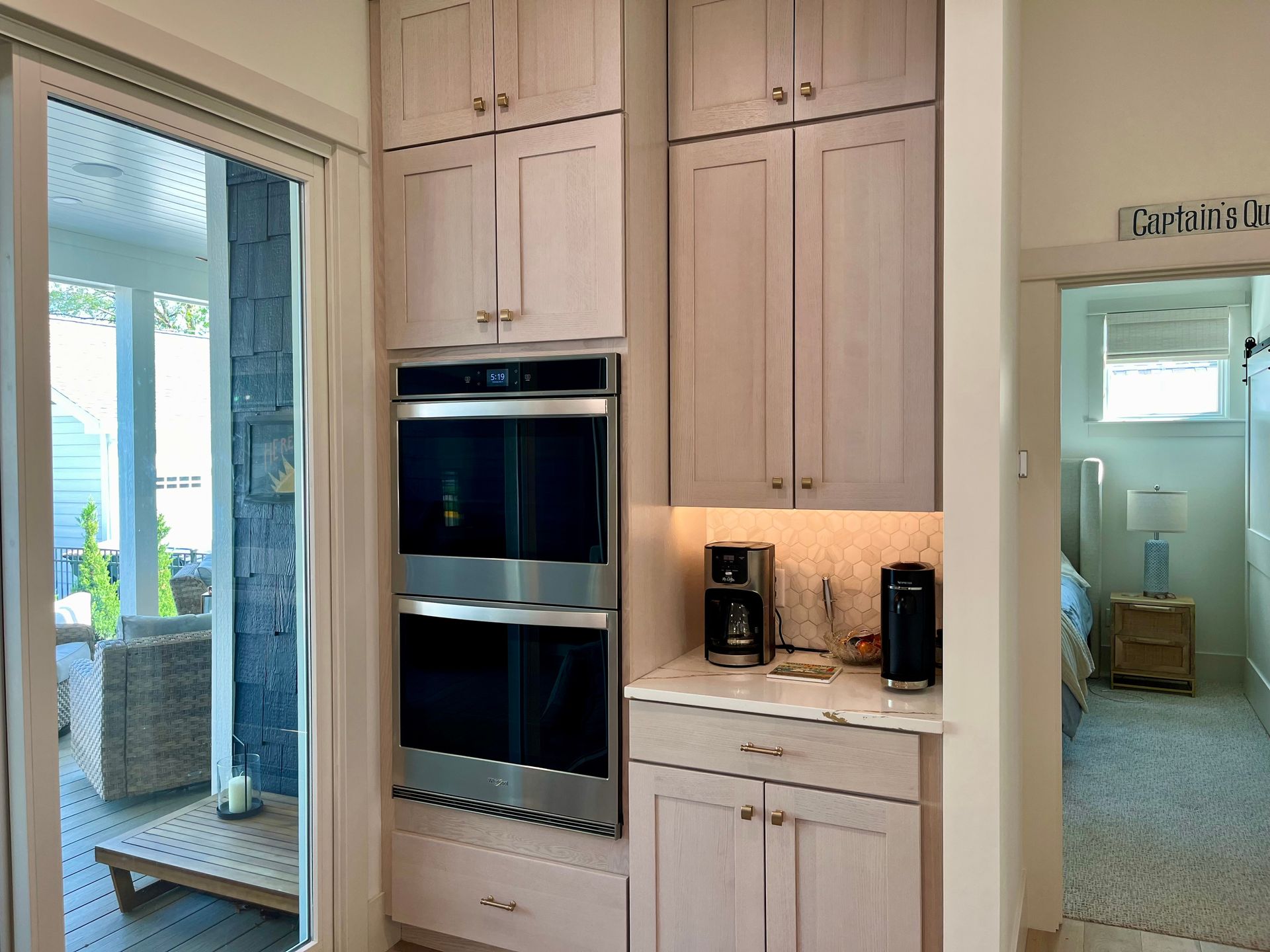 A kitchen with stainless steel appliances and white cabinets.