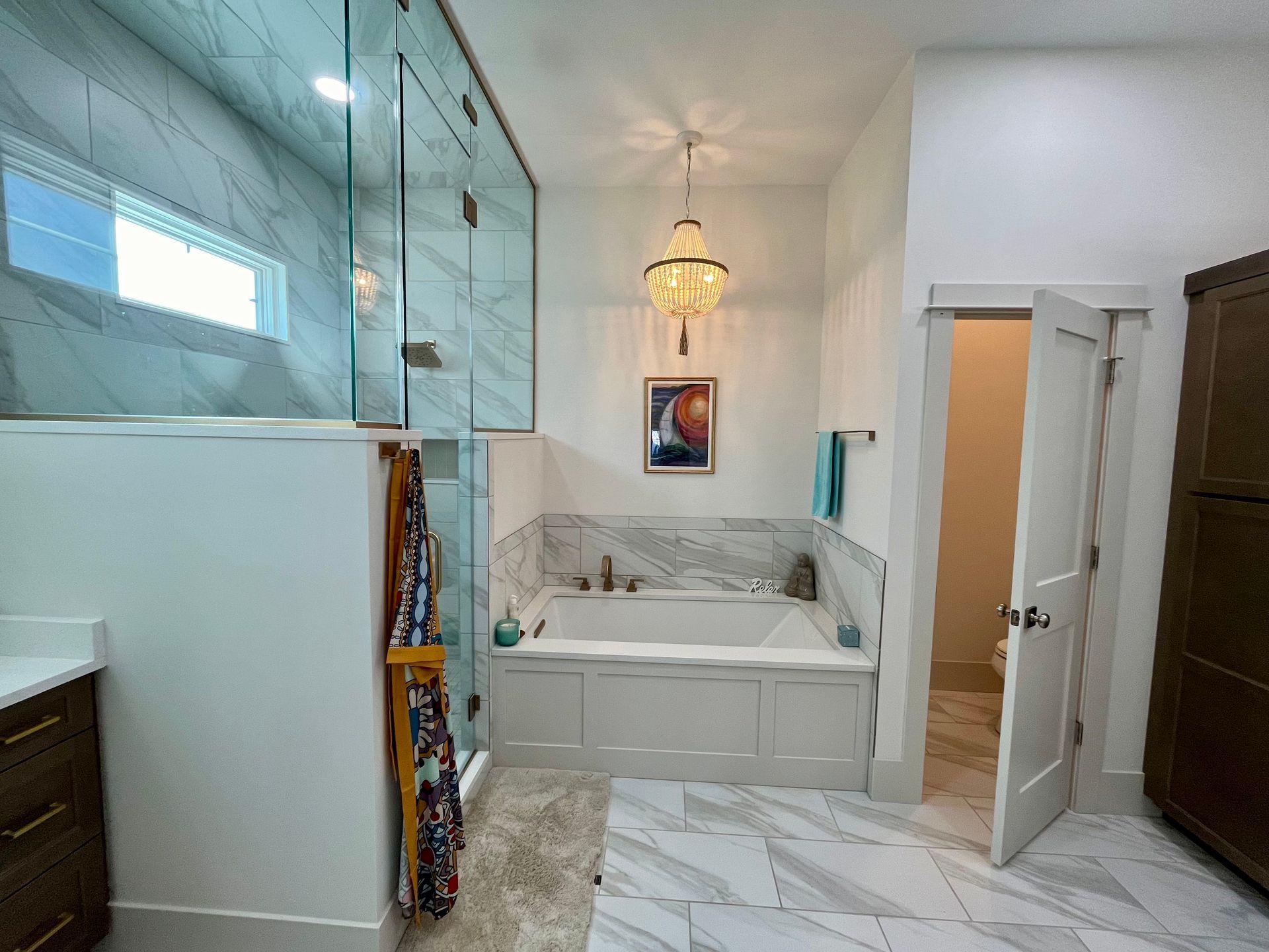 A bathroom with a bathtub and a walk in shower.