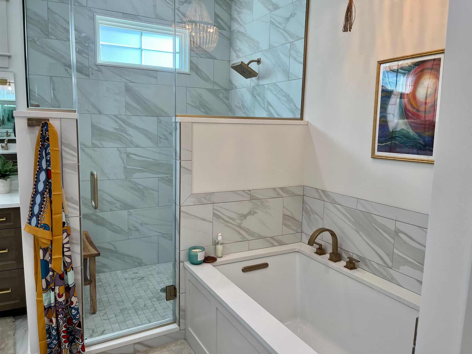 A bathroom with a bathtub and a walk in shower.