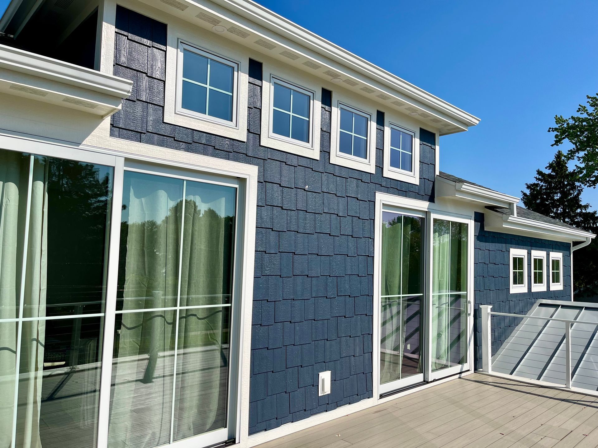 A large house with lots of windows and sliding glass doors