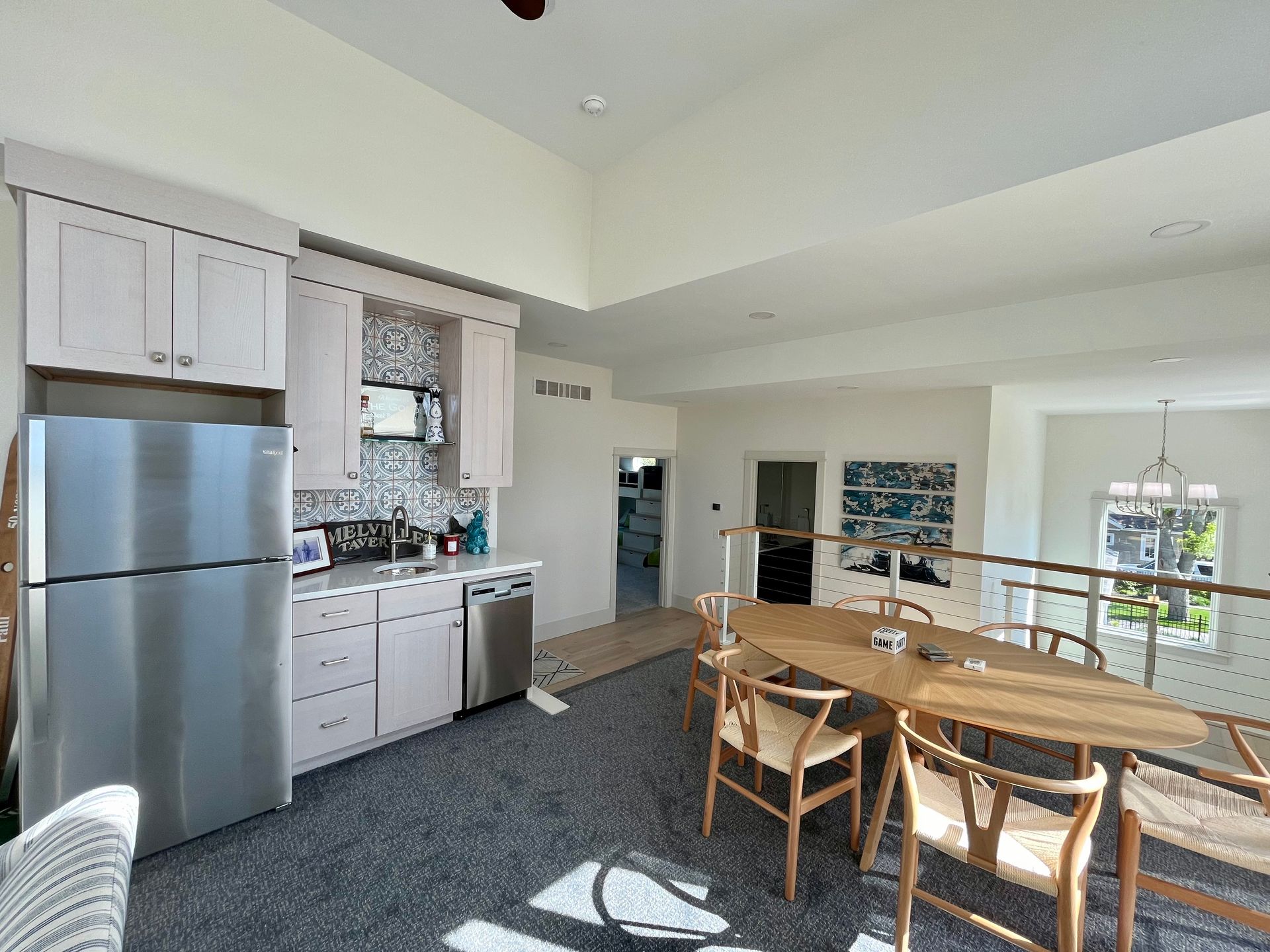 A kitchen with a stainless steel refrigerator , a table and chairs.