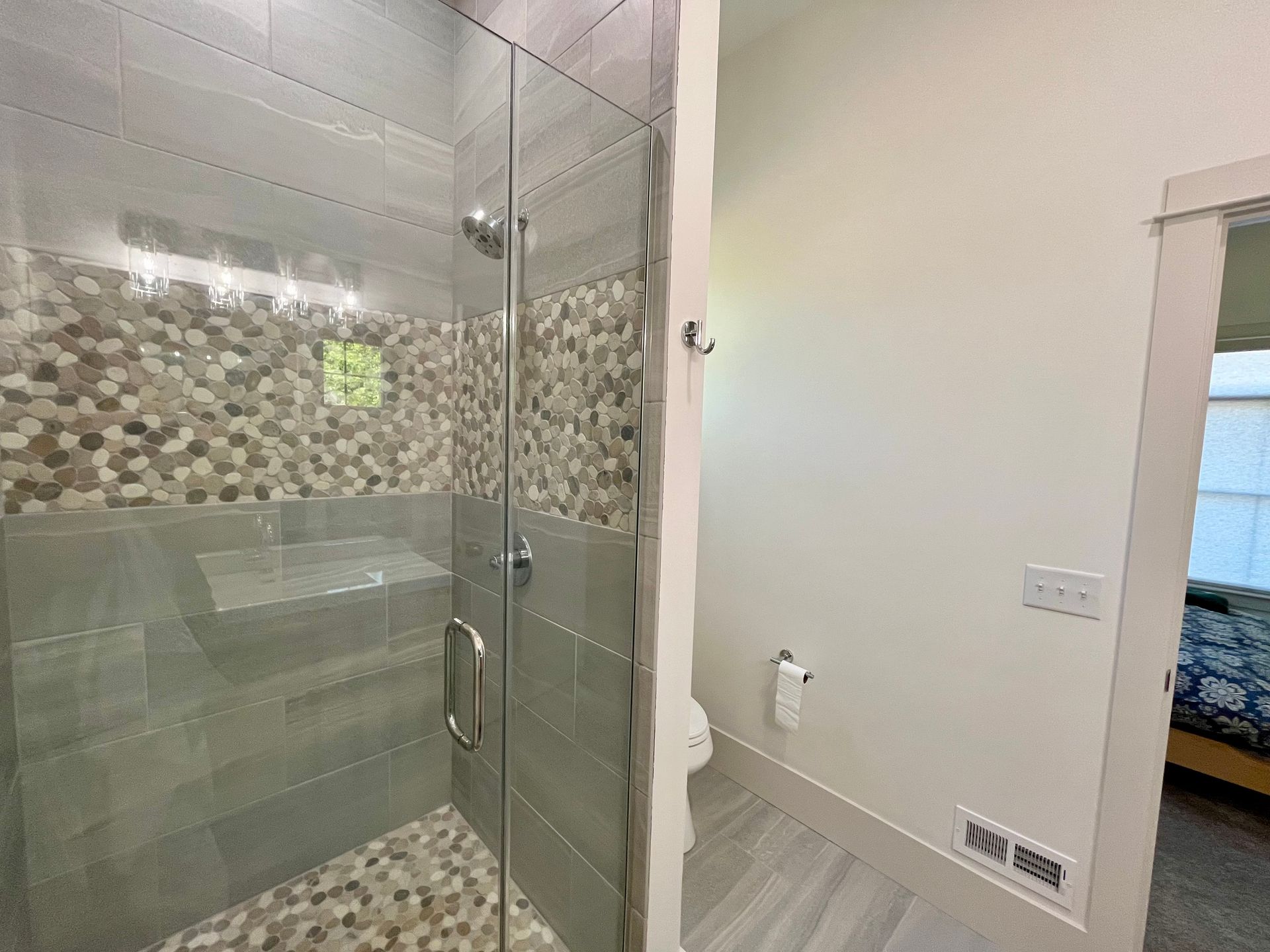 A bathroom with a walk in shower and a bathtub.
