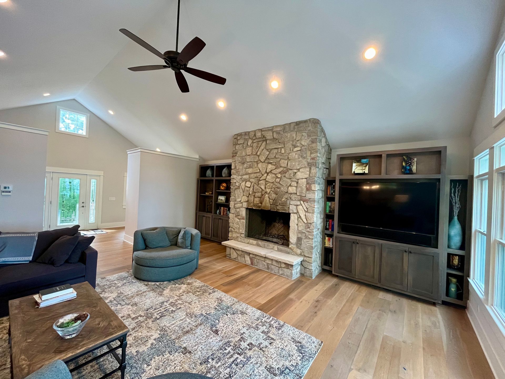 A living room with a fireplace and a flat screen tv.