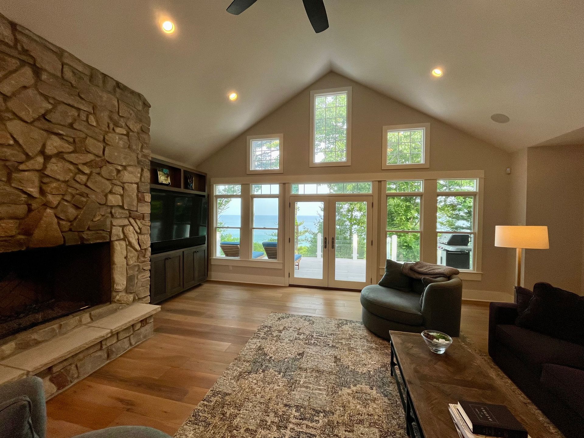 A living room with a fireplace and lots of windows