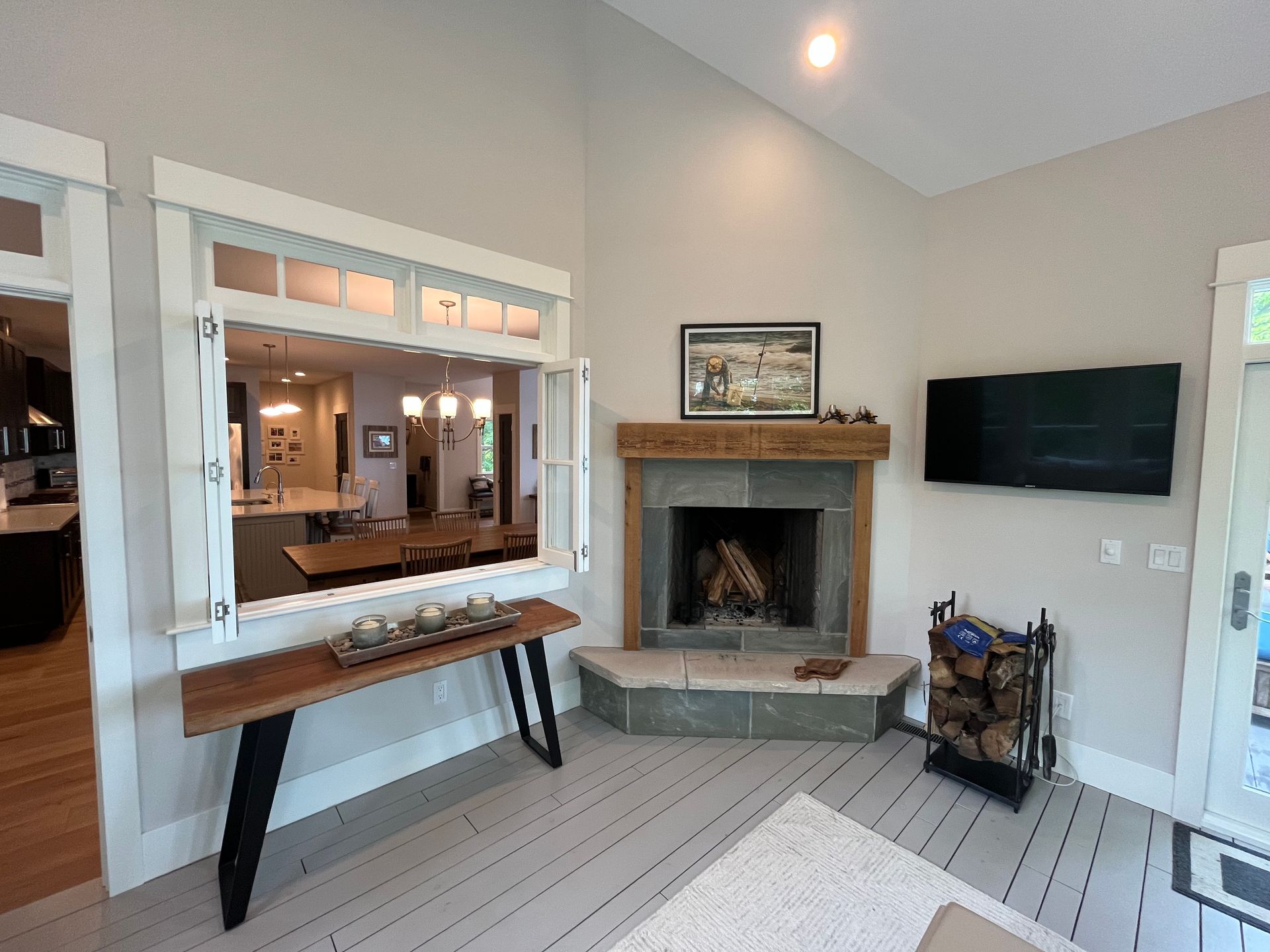 A living room with a fireplace and a flat screen tv.
