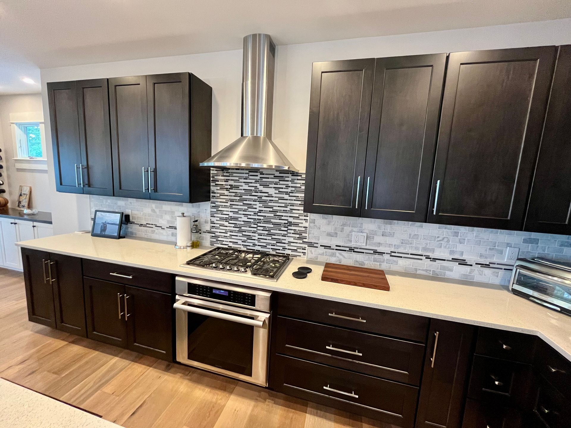 A kitchen with black cabinets and stainless steel appliances