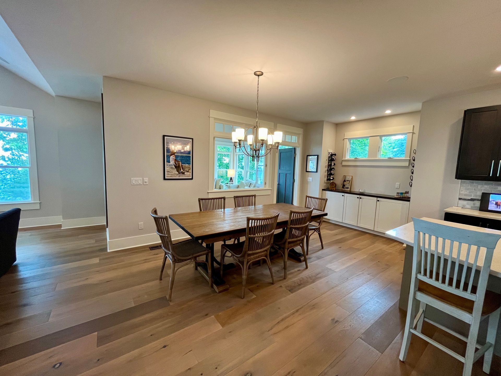 A dining room with a table and chairs and a chandelier.