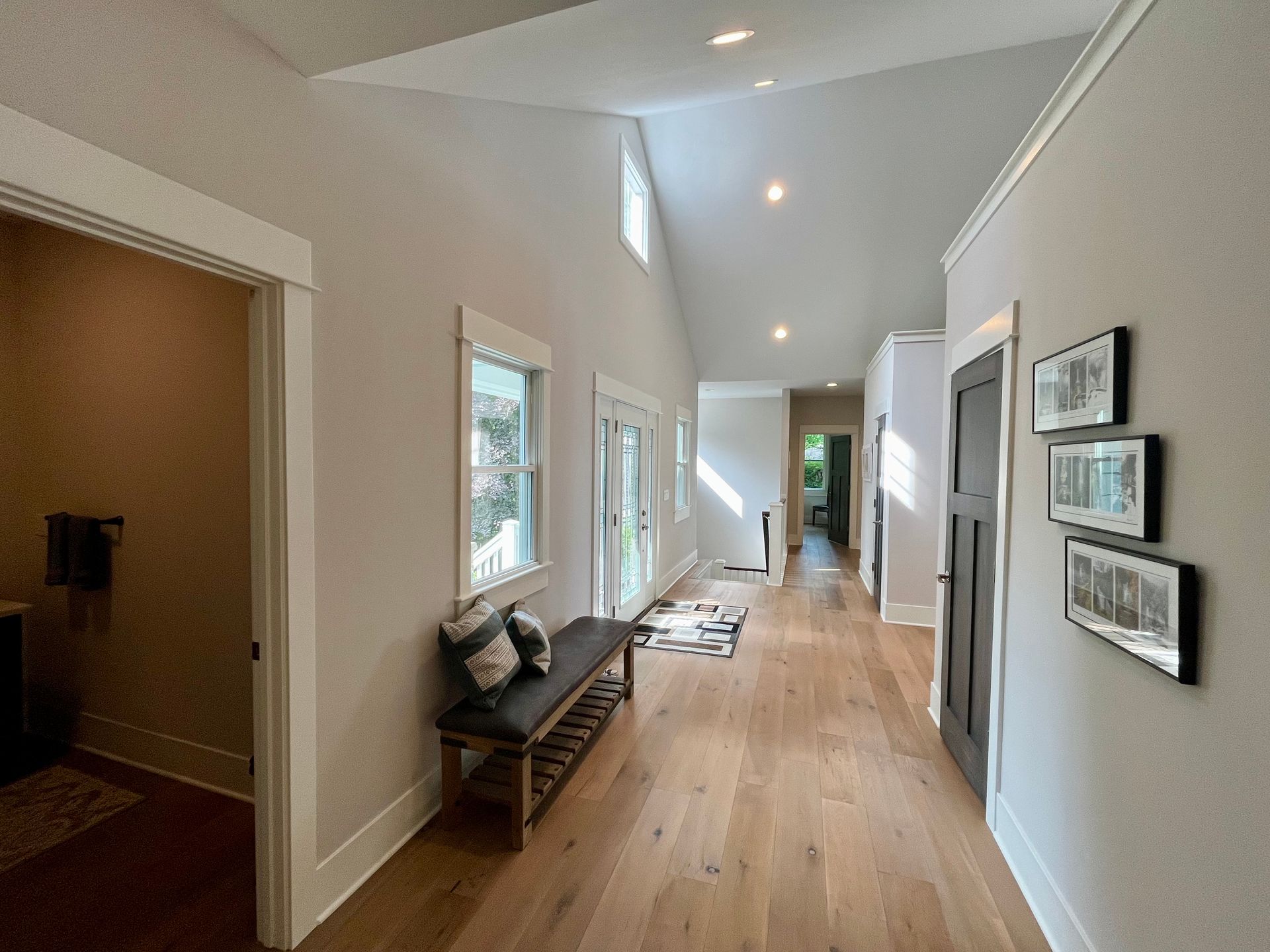 A long hallway with a bench in the middle of it