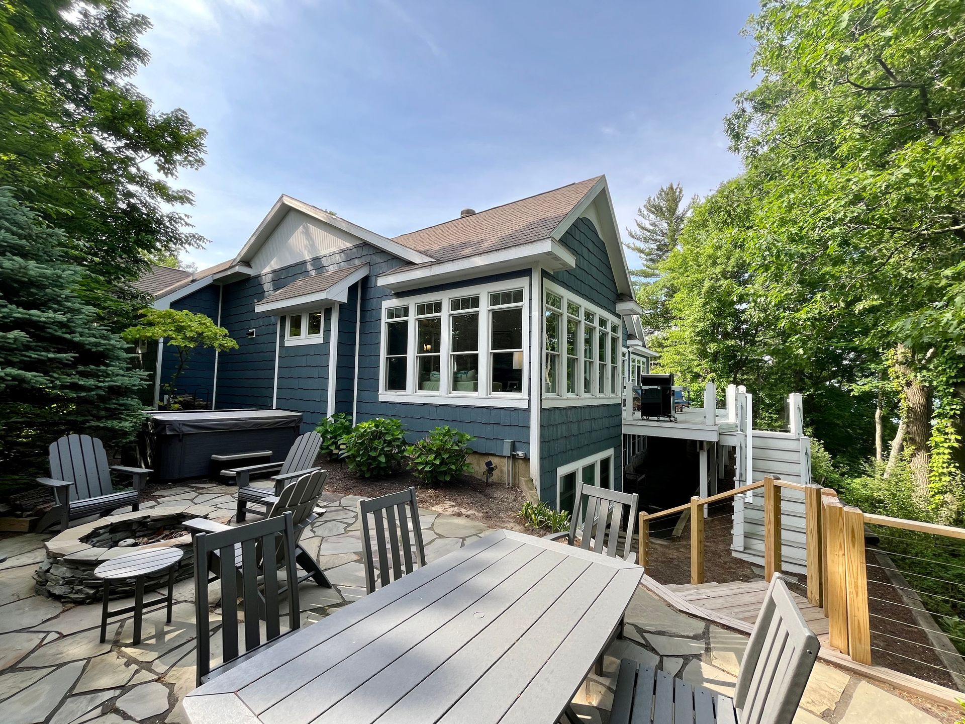A blue house with a table and chairs in front of it
