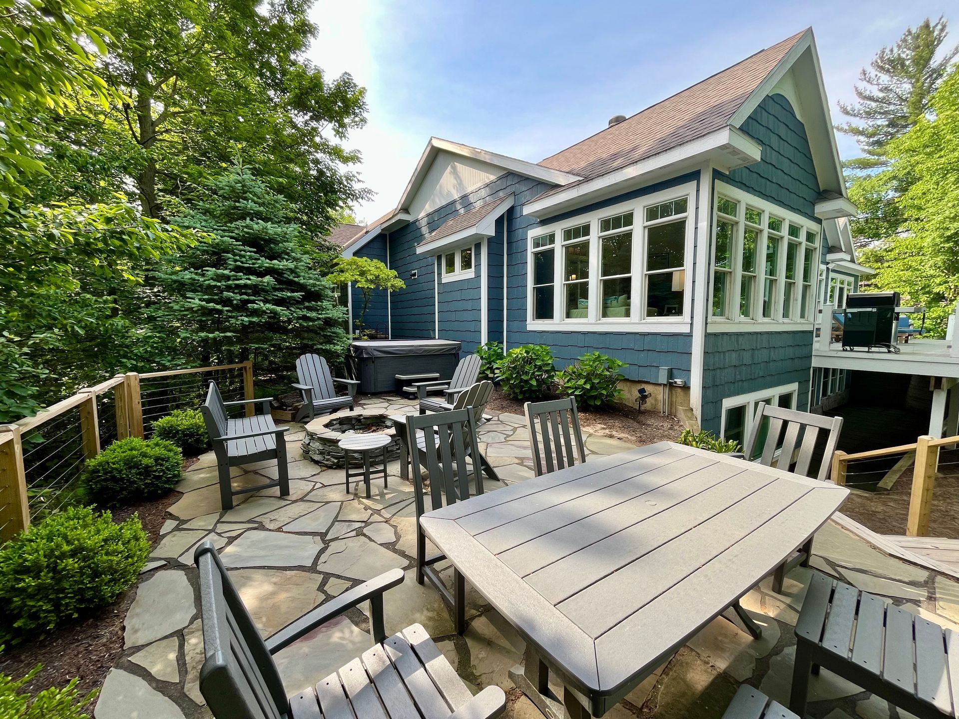 There is a table and chairs on the patio in front of the house.