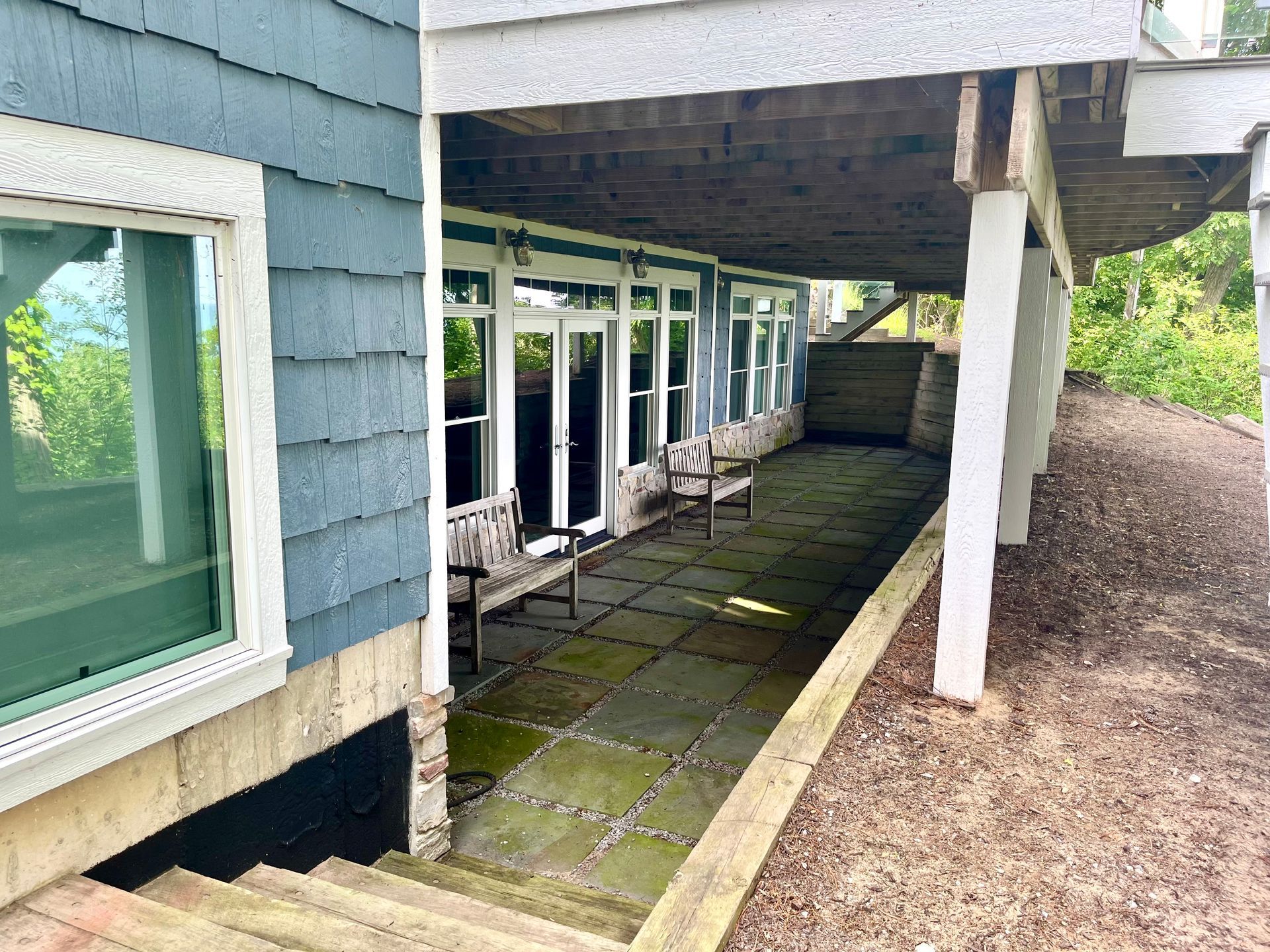 A house with a covered porch and stairs leading up to it.